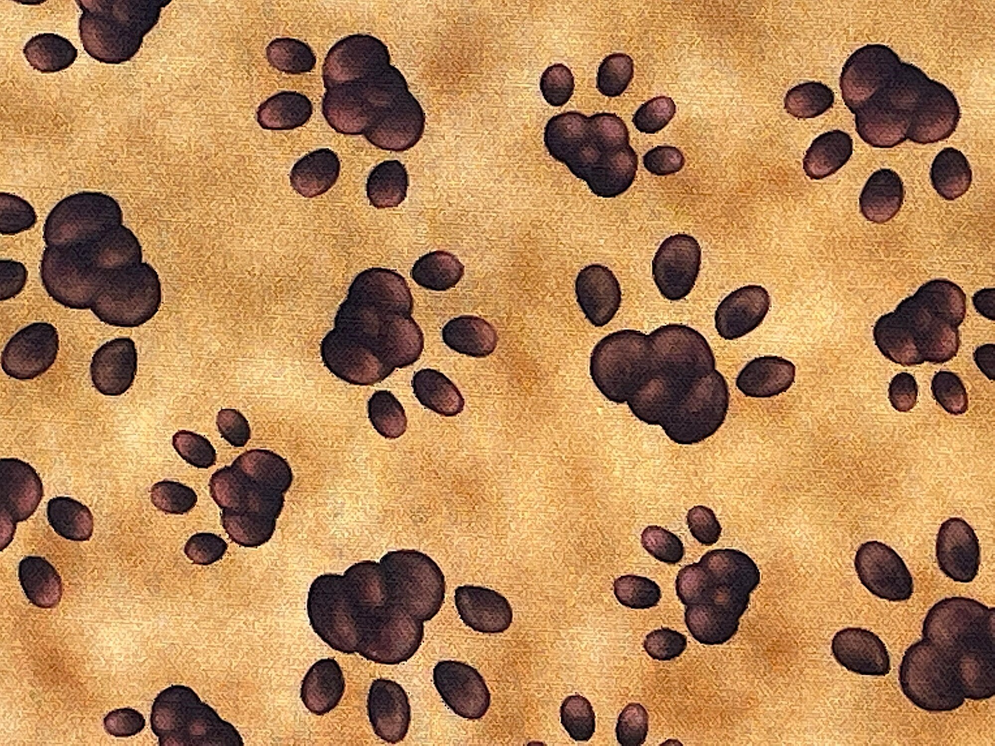 Brown paw prints on cotton fabric.