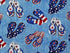 Close up of red, white and blue flip flops on a blue background.