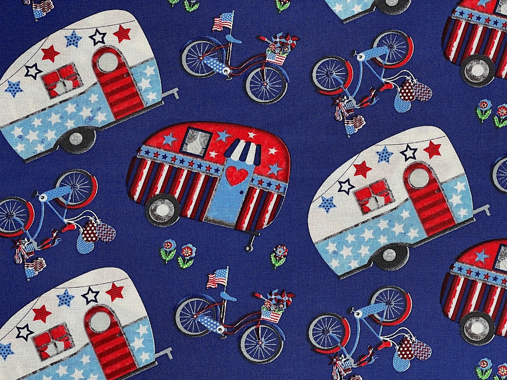 Close up of red white and blue travel trailers and bicycles.