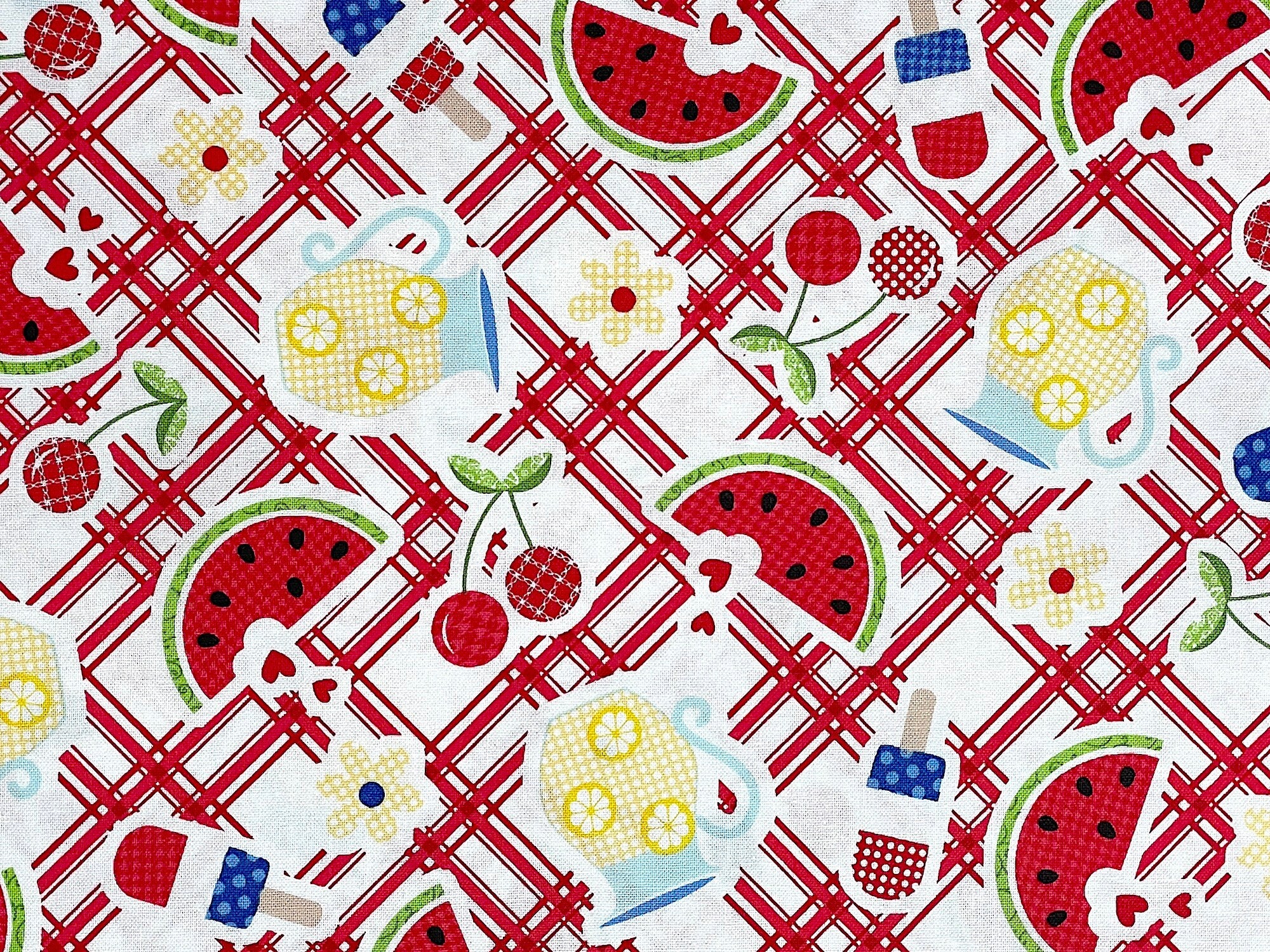 This fabric looks like a Red and White Plaid Tablecloth with pieces of Watermelon, picture's of lemonade and red white and blue ice cream bars