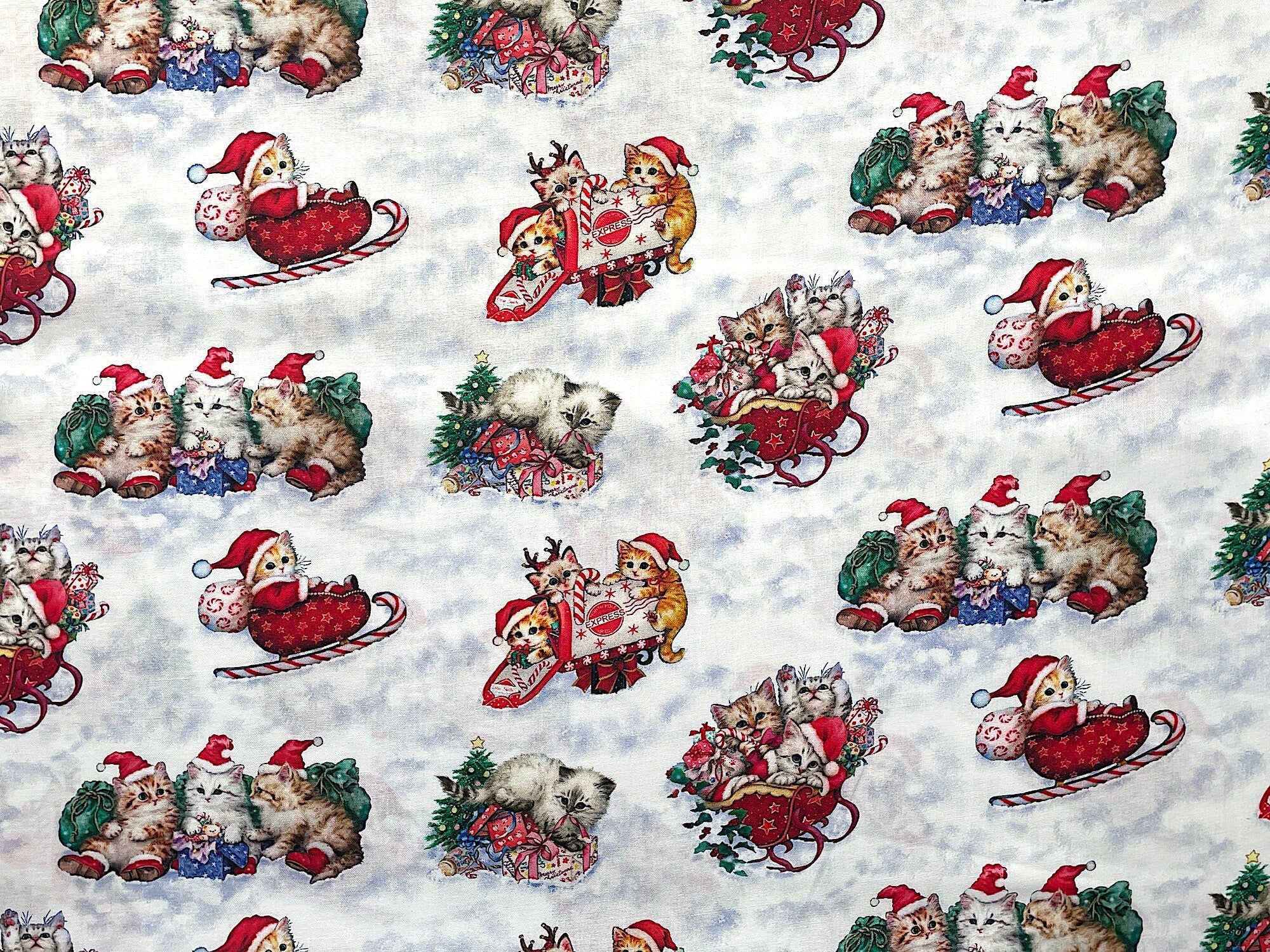 This design has sweet little kittens in Christmas Sleighs, in a mailbox, and on a mound of presents.