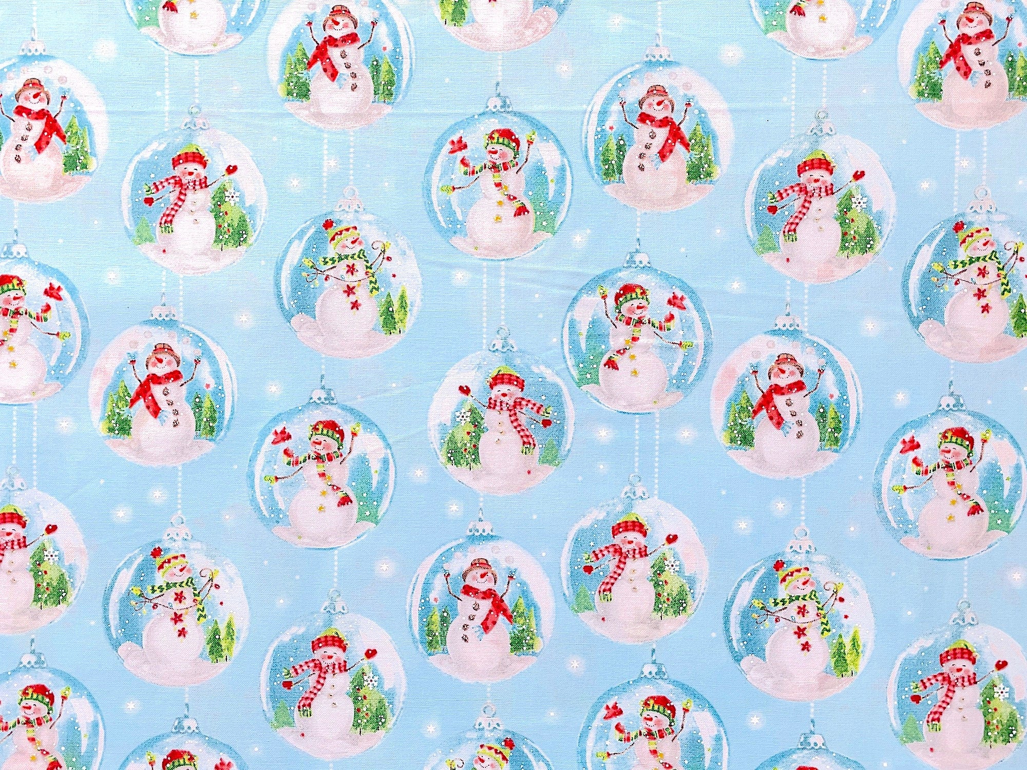 This holiday fabric from Windham Fabrics is covered with Snow Globes with Cute Happy Snowmen and birds inside.