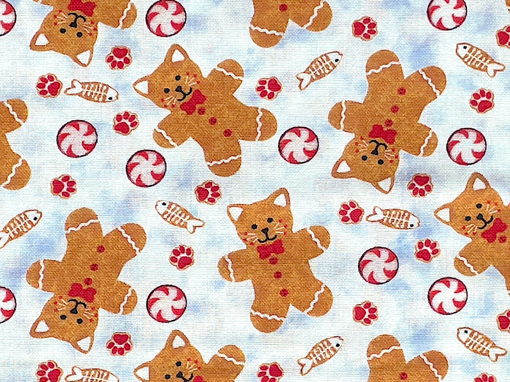 Close up of gingerbread kittens, candies and paw prints.