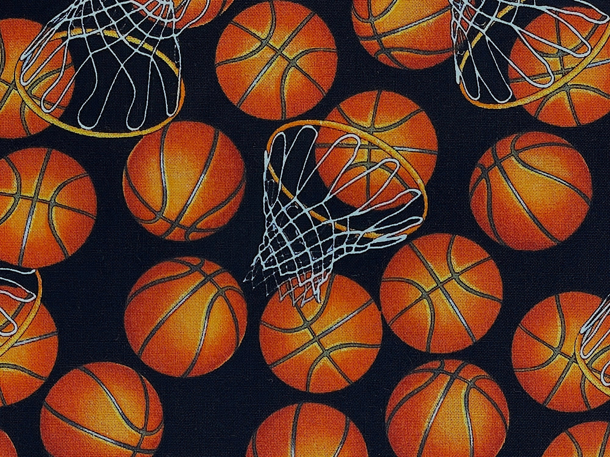 Close up of orange basketballs and basketballs hops on a black background.