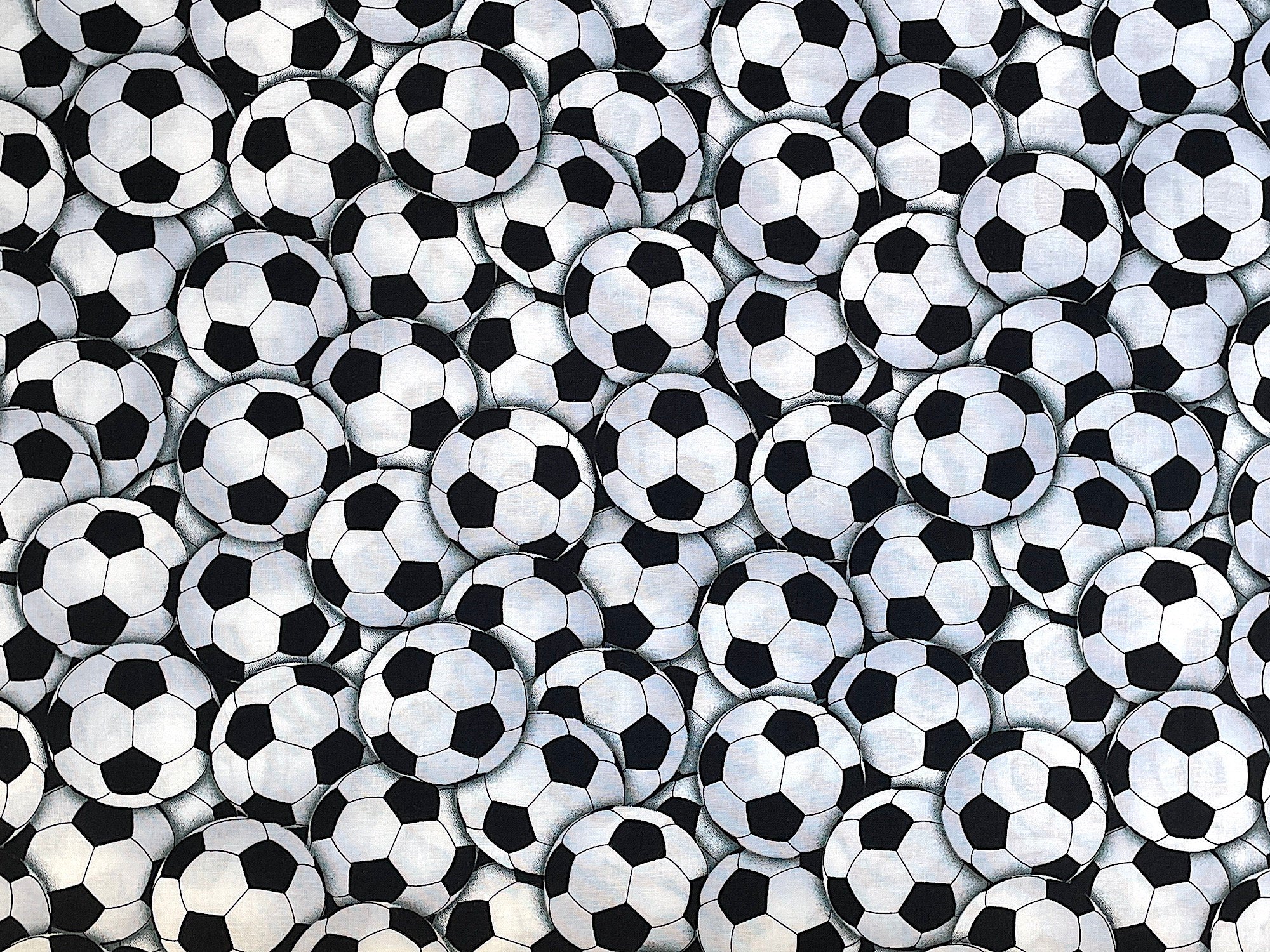 Cotton fabric covered with soccer balls.