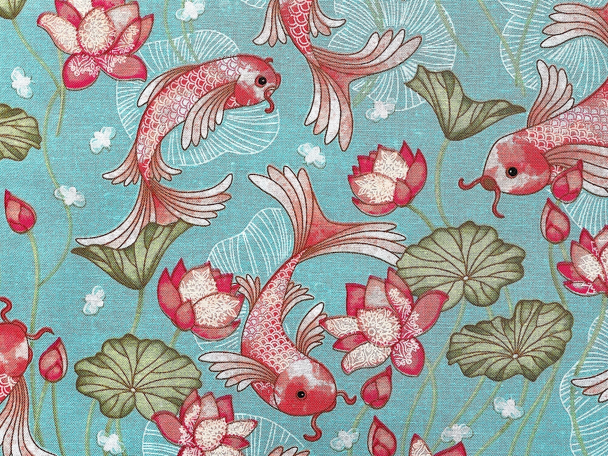 Close up of orange and white koi and water lilies.