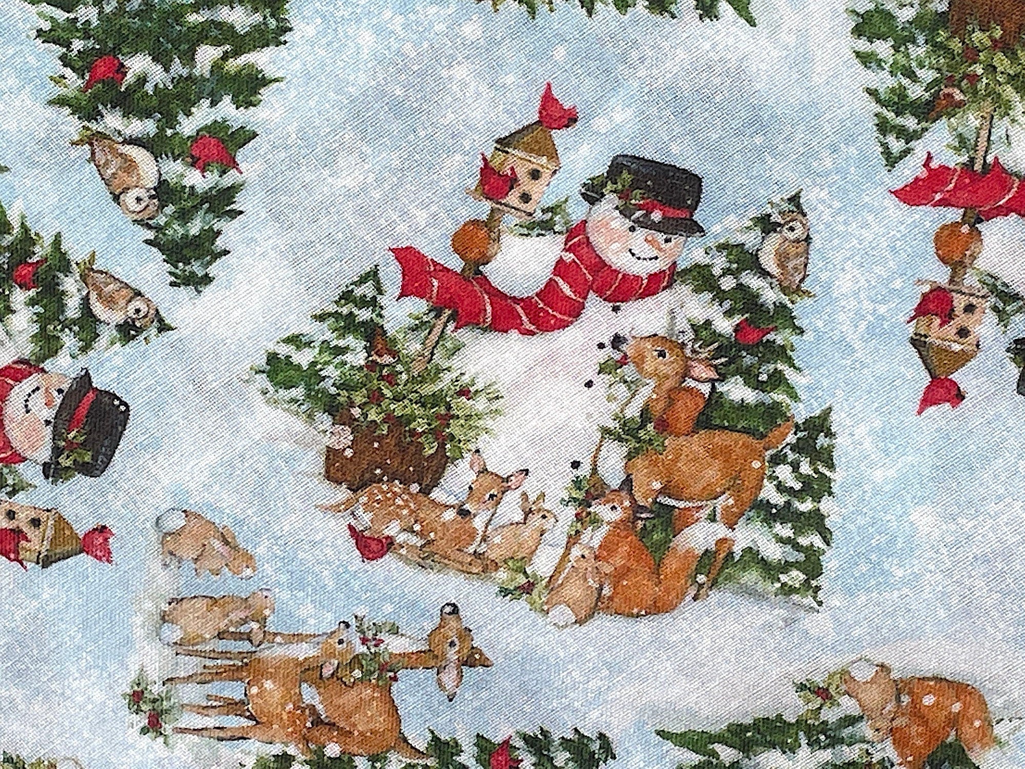 Close up of a snowman, deer, rabbits, fox beside snow covered trees