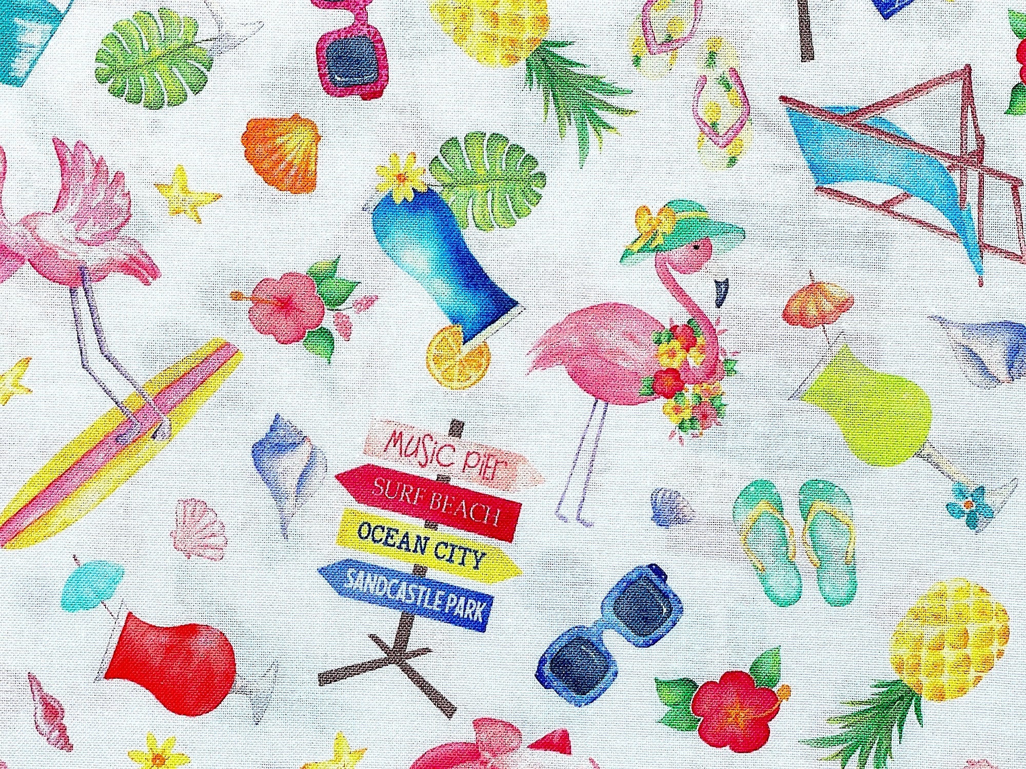 This fabric is part of the Fun In The sun collection. This white cotton fabric is covered with sunglasses, pineapples, pink flamingos, beach chairs, sand pail and shovels, beach signs and beverages