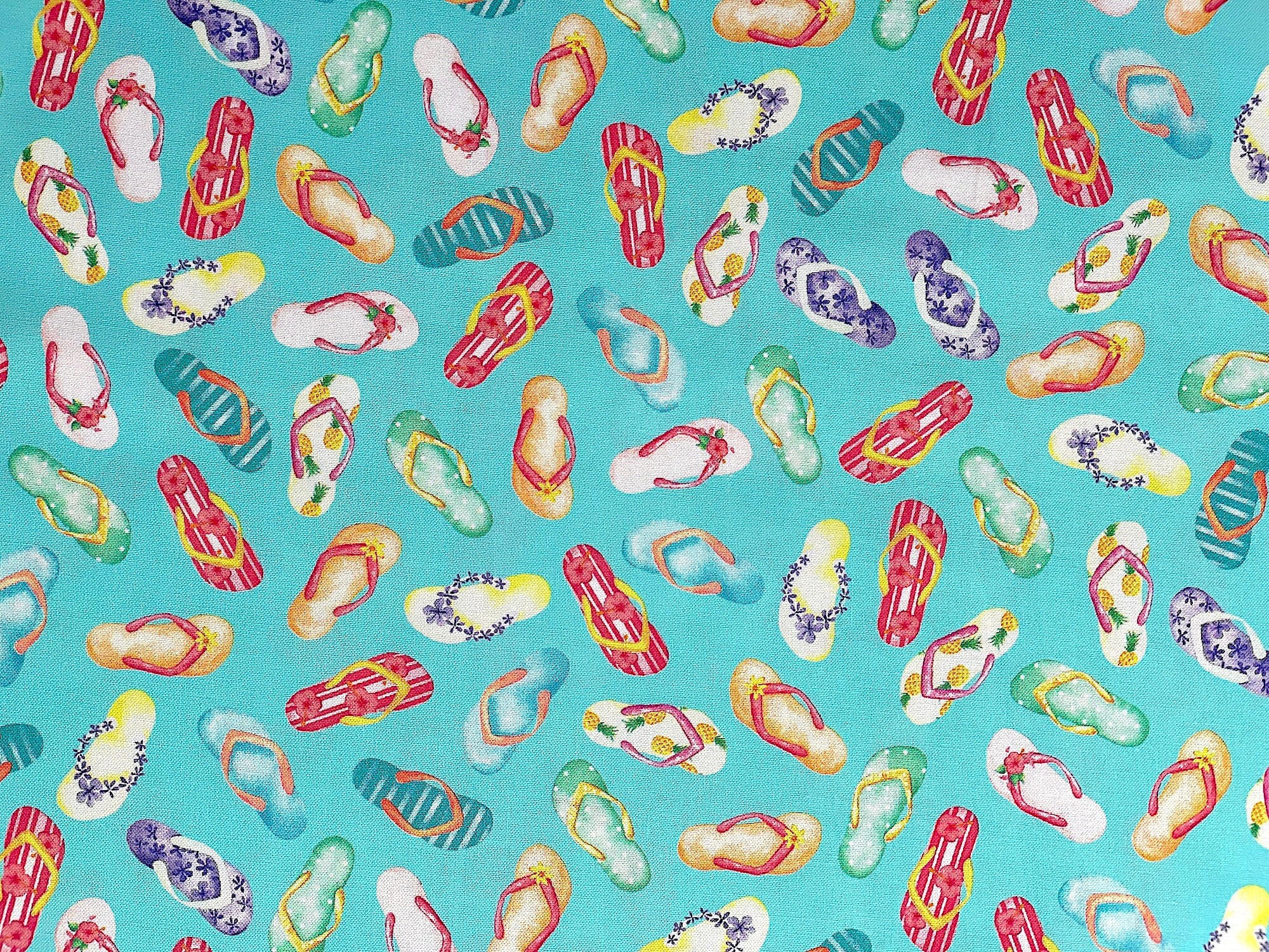 This fabric is part of the Fun In The sun collection. This turquoise fabric is covered with colorful flip flops