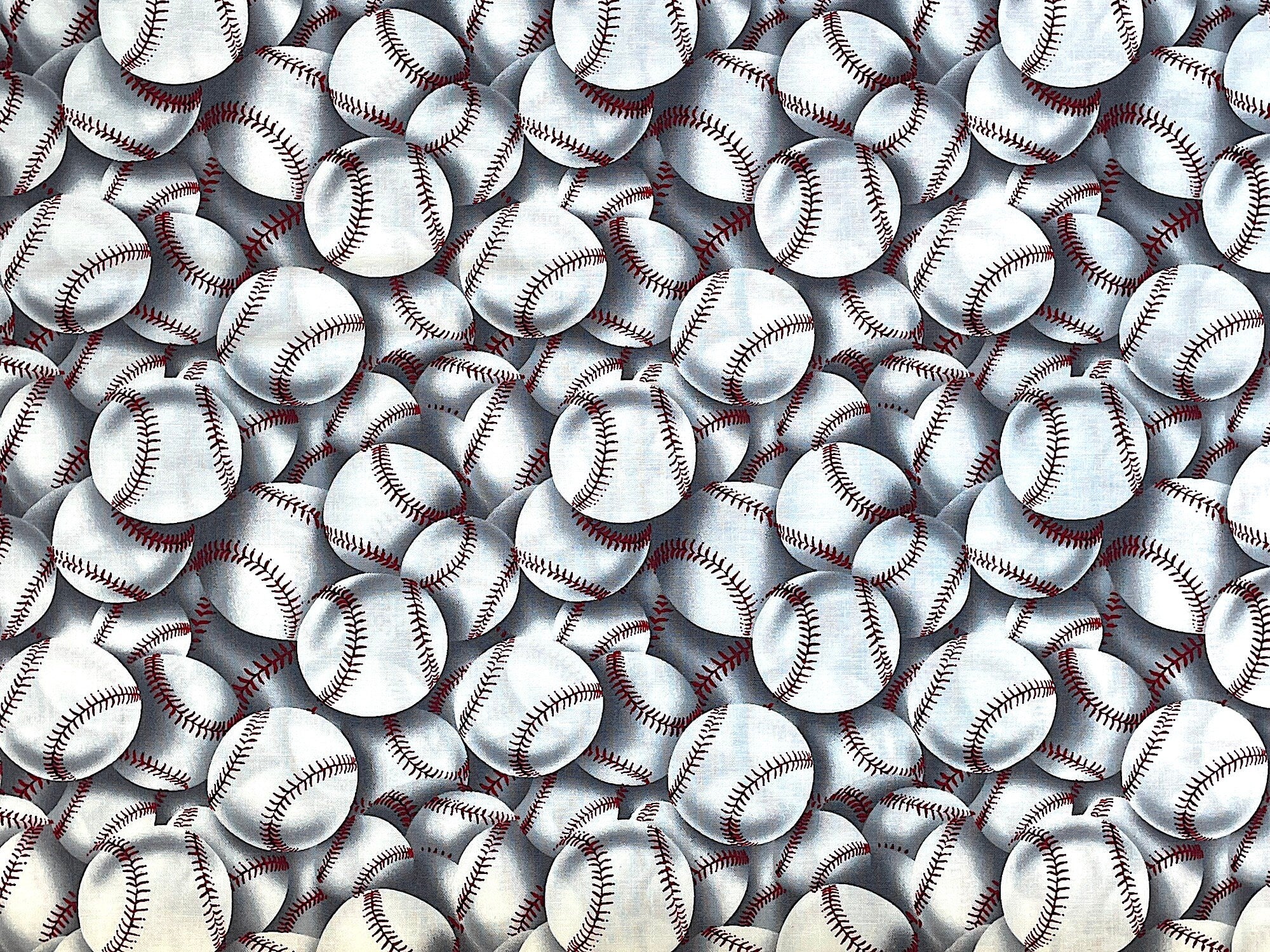 This cotton fabric is covered with baseballs. The colors in this fabric are white, grey and red.