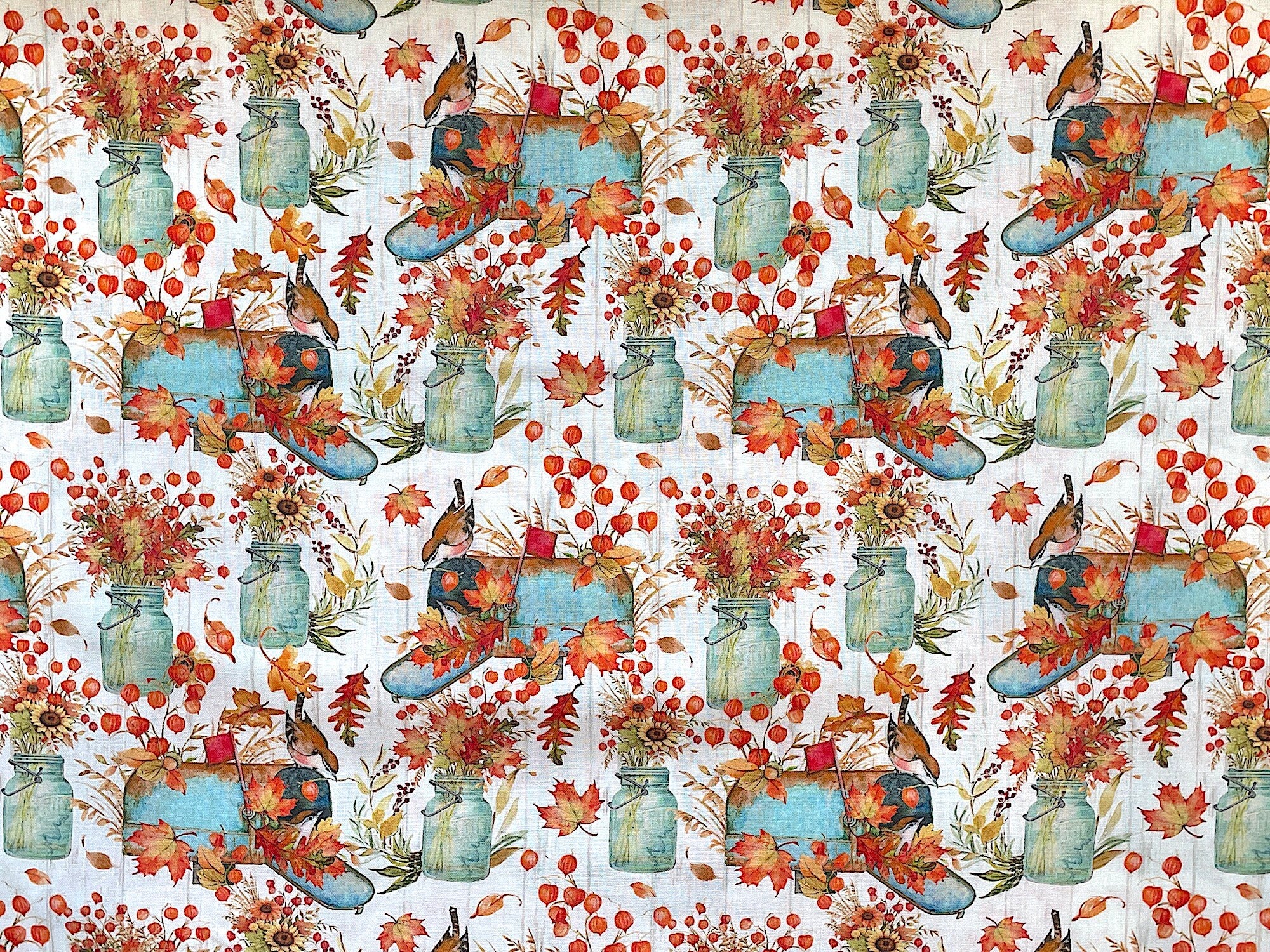 This fall themed fabric is covered with mailboxes which are surrounded by leaves. Some of the mailboxes have birds on them. There are also jars filled with fall flowers such as sunflowers.