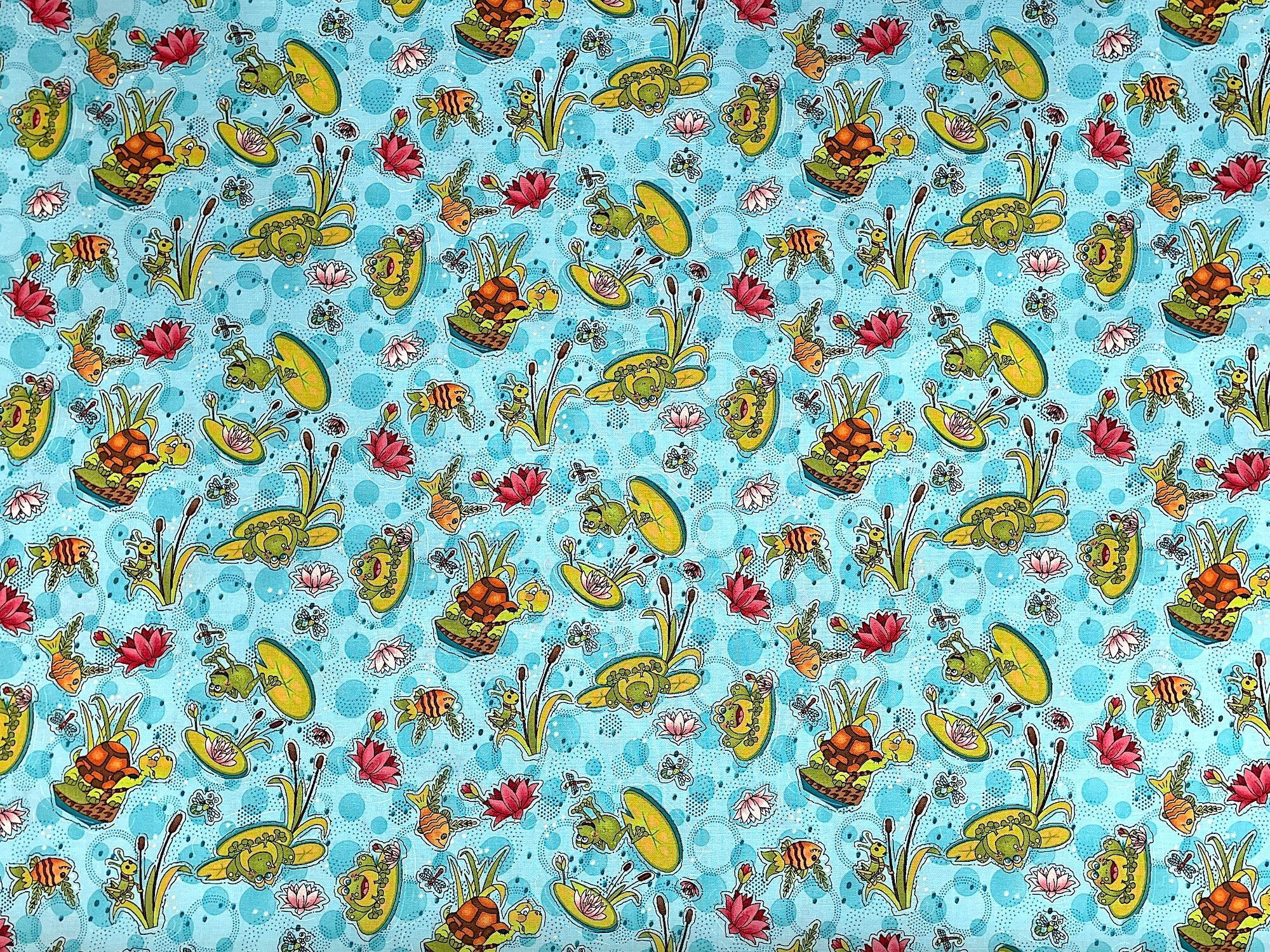 This cotton fabric is called Water Lily and is covered with frogs, fish, grasshoppers, water lilies and more. 