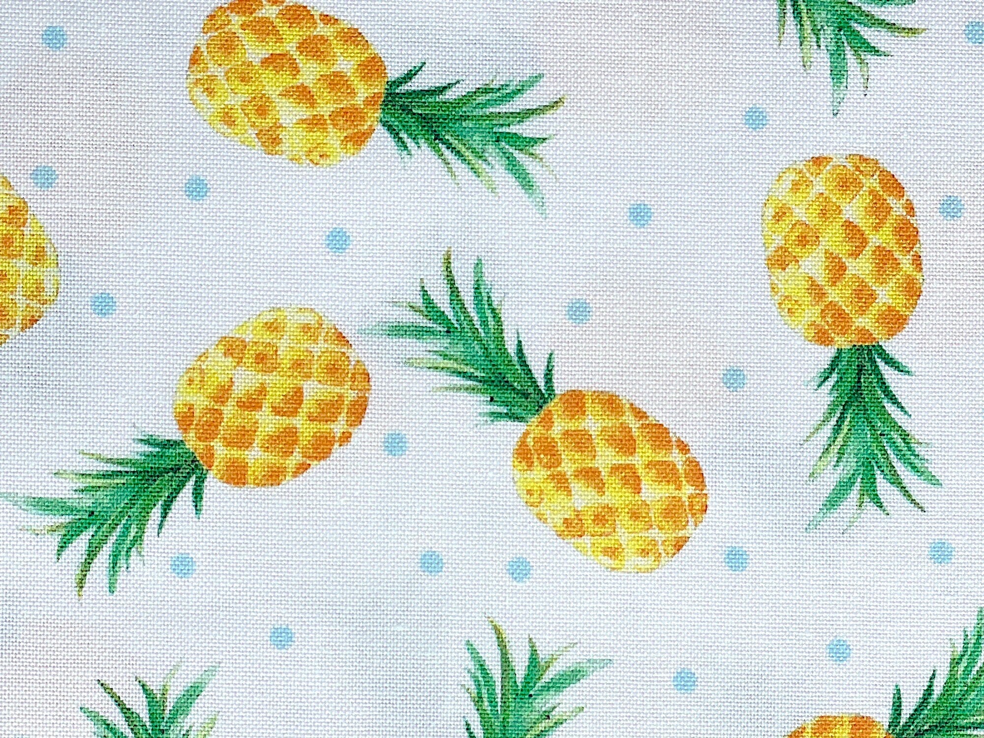 White cotton fabric covered with pineapples.