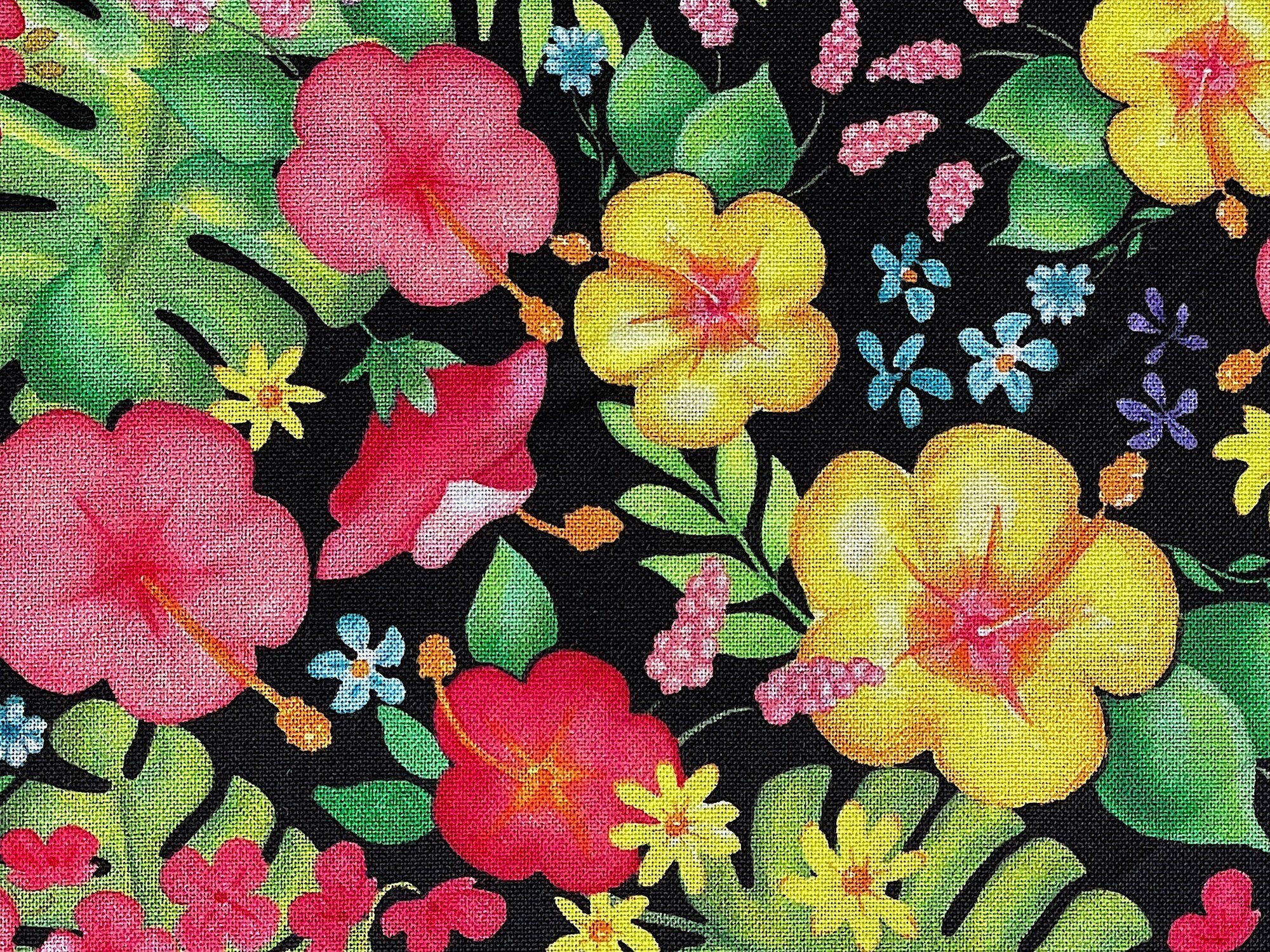 Close up of red, yellow, pink and purple flowers and green leaves.