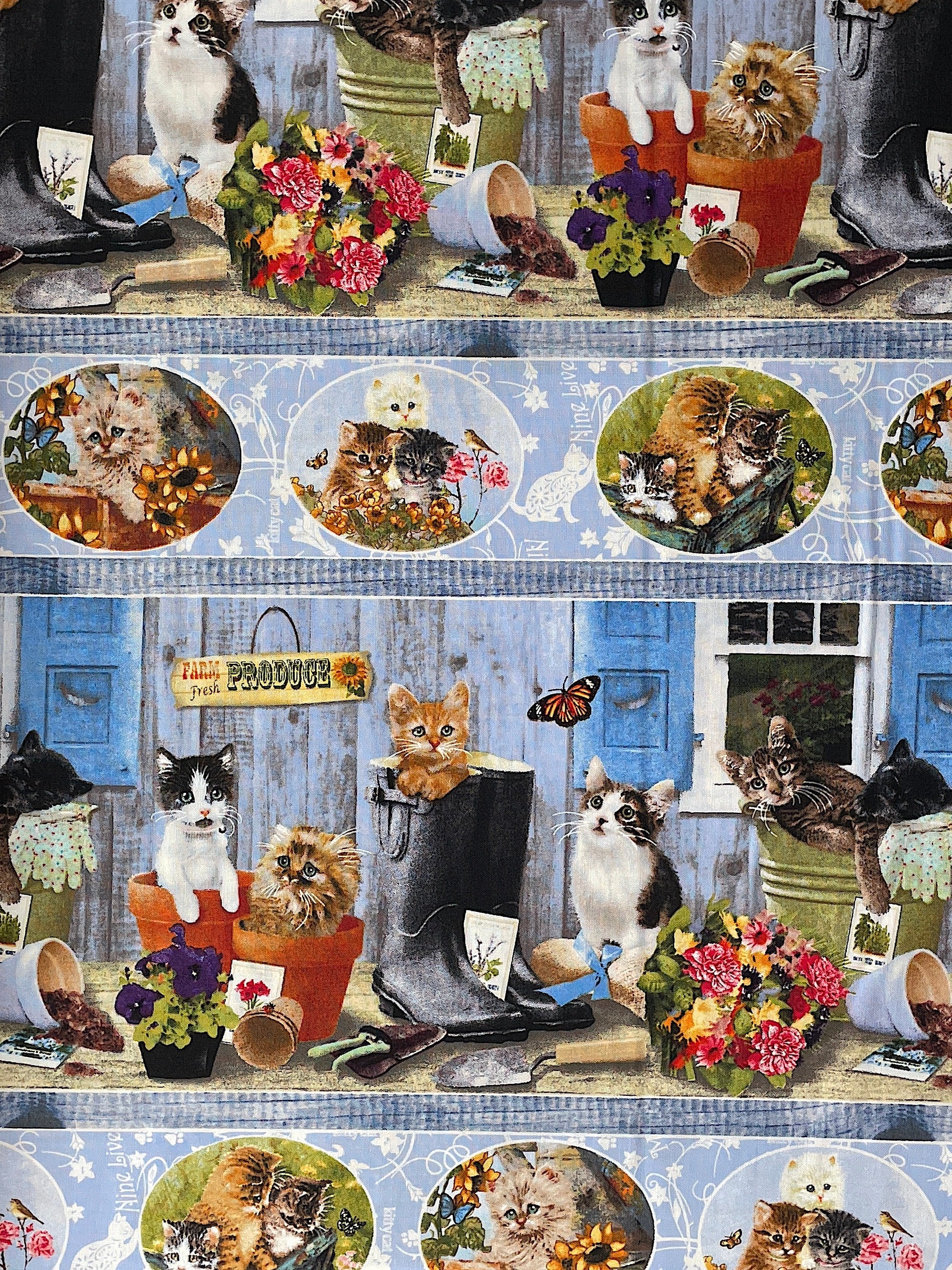 This border stripe fabric is covered with kittens. Some of the kittens are in pots while others are in boots. There are also pots of flowers, garden tools and seed packets.