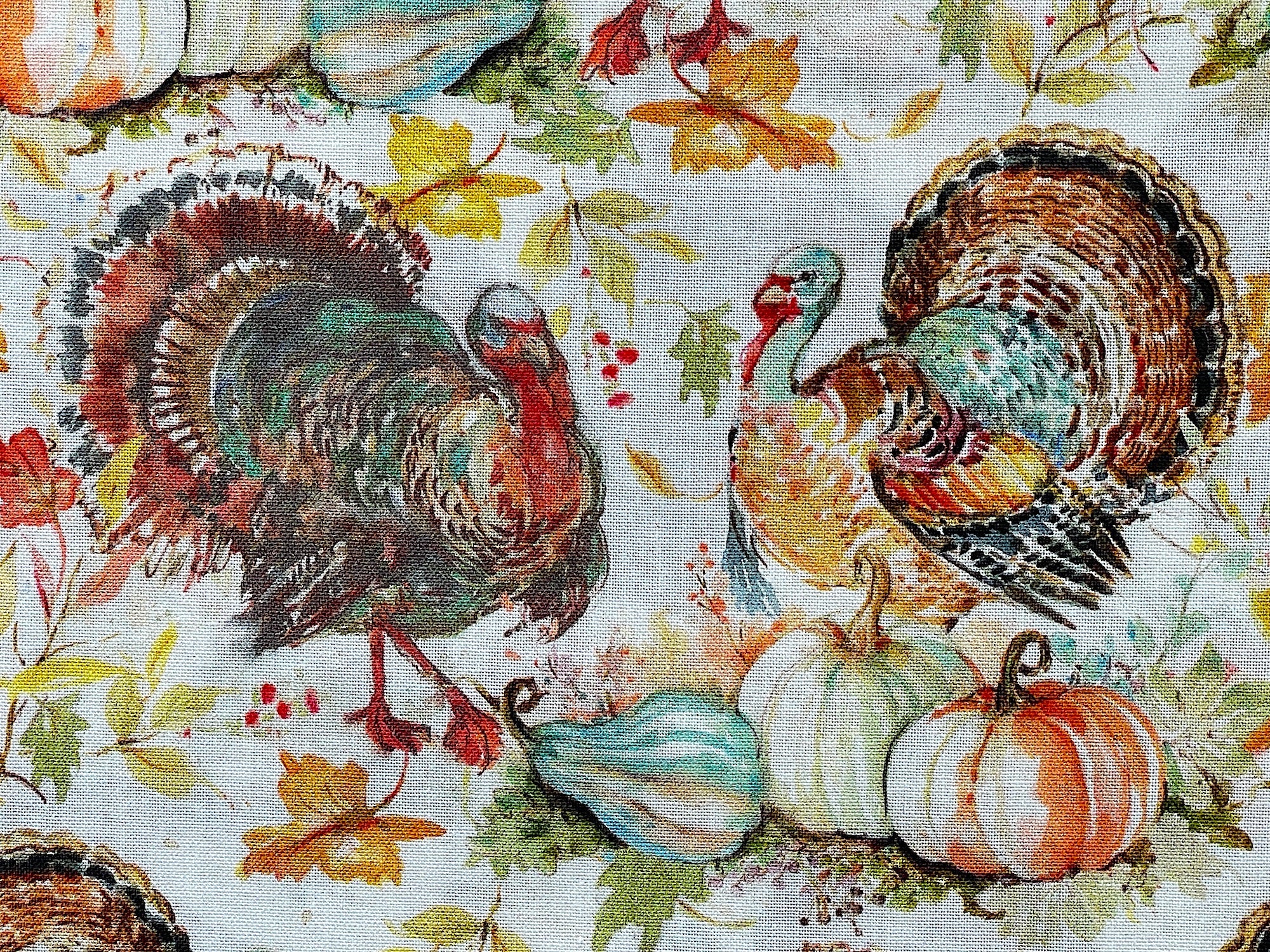 Close up of 2 turkeys, pumpkins and fall leaves.