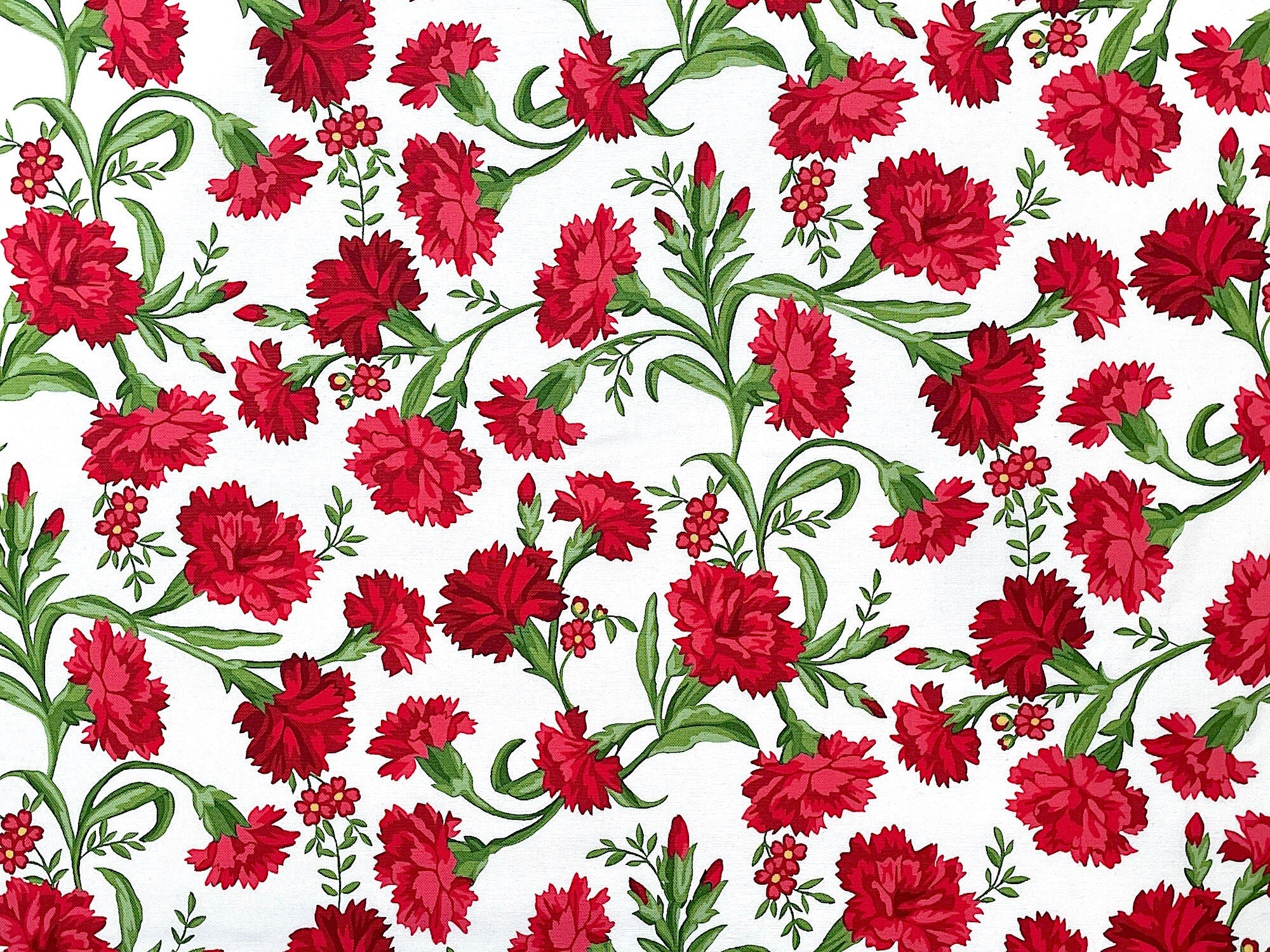 White cotton fabric covered with red carnations and green stems and leaves.