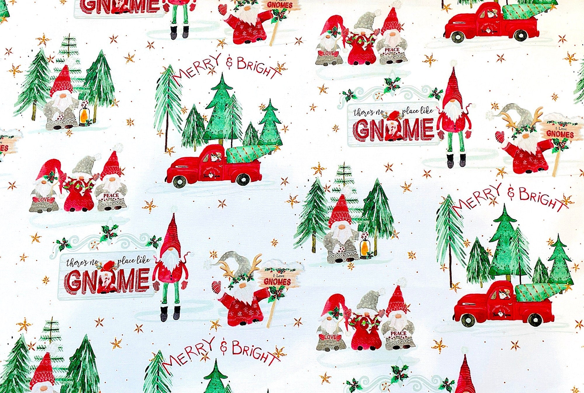 White cotton fabric covered with red trucks, green trees and gnomes.