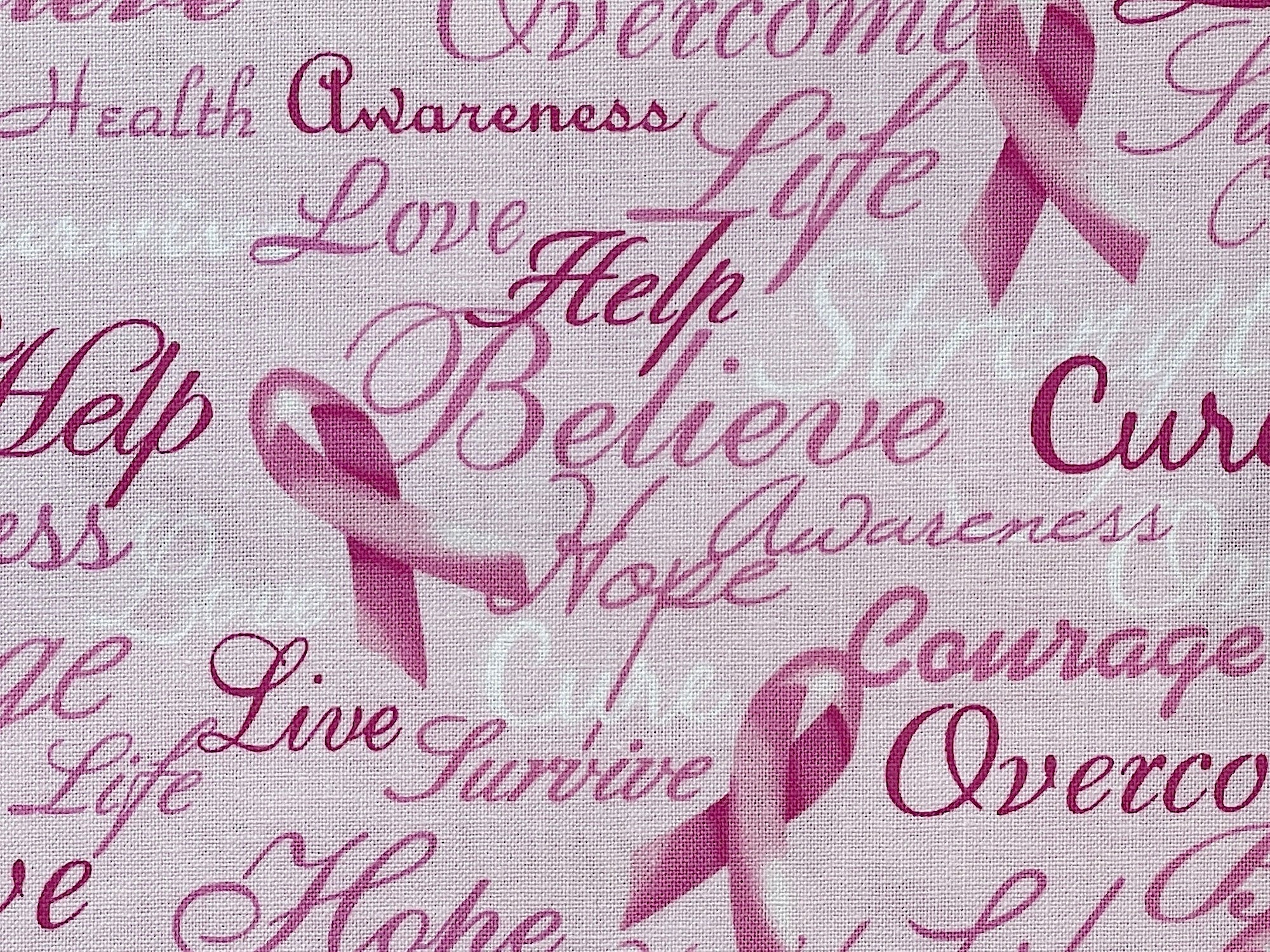 Light pink cotton fabric covered with words such as love, life, help, believe and more.