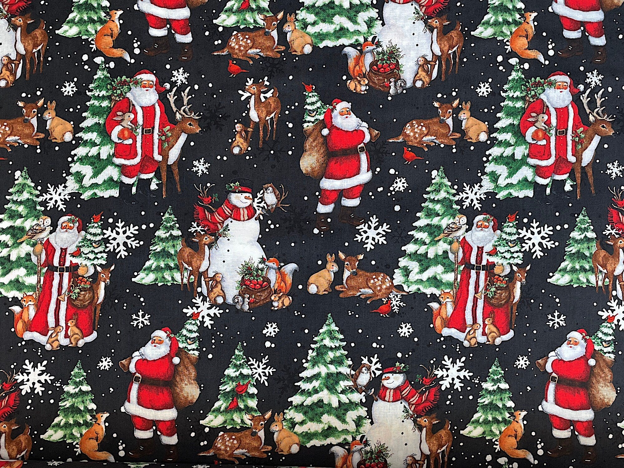 Black cotton fabric covered with Snowmen and Santa's and trees.