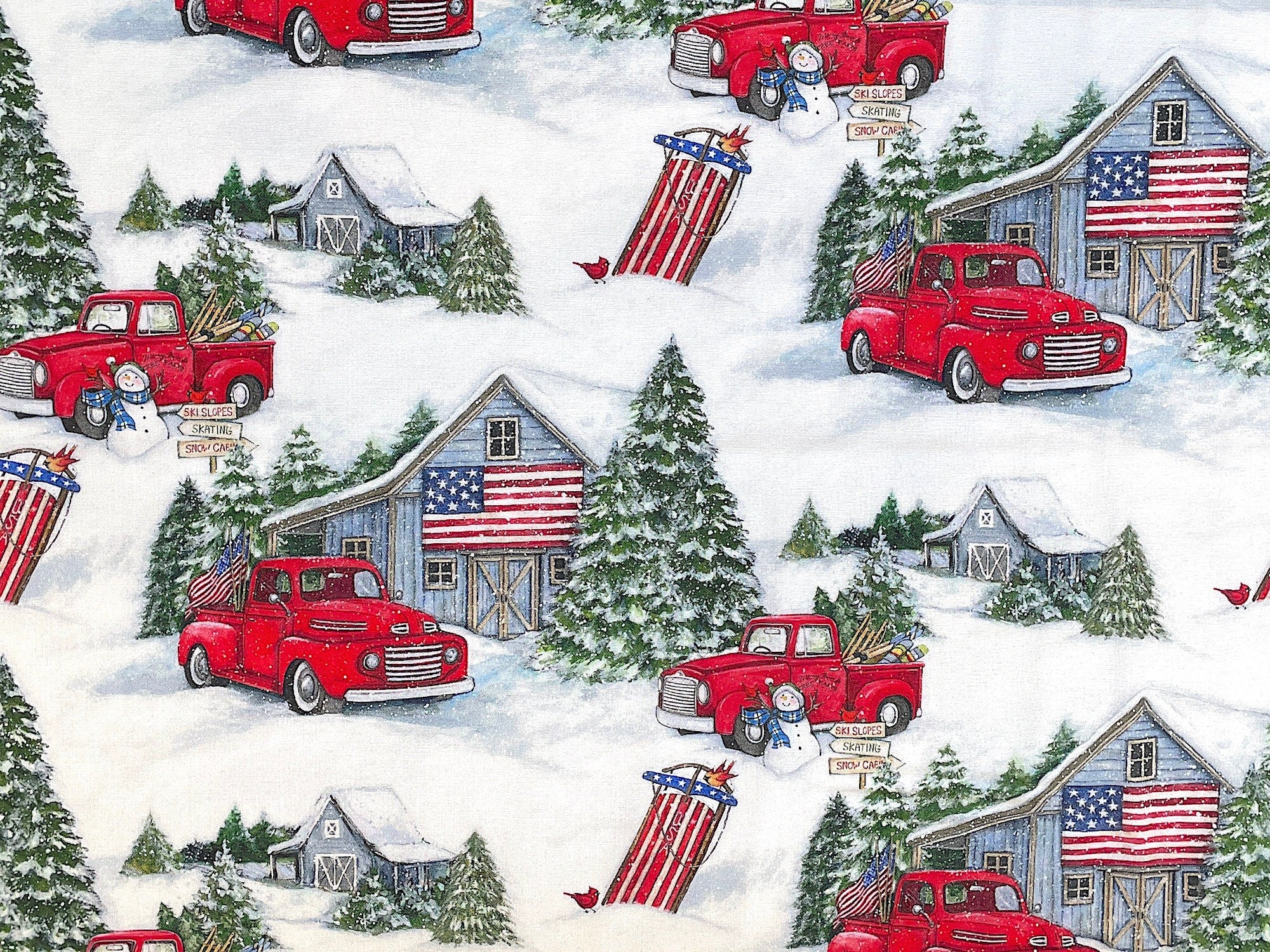 This fabric is snow covered and has red trucks, barns, snow covered trees, sleds and more. There are USA flags on the barns.