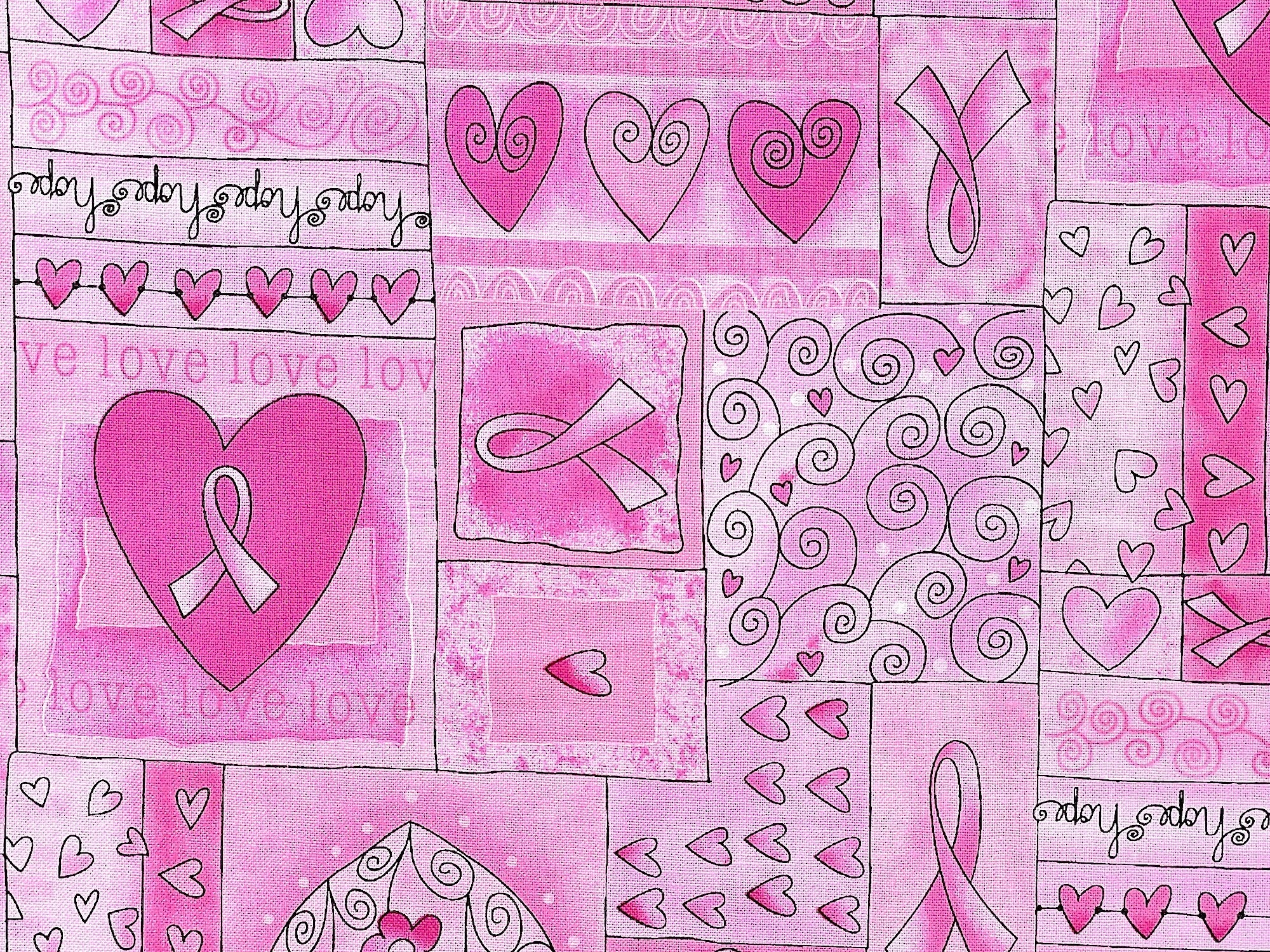 Close up of pink cotton fabric with awareness ribbons, hearts and more.