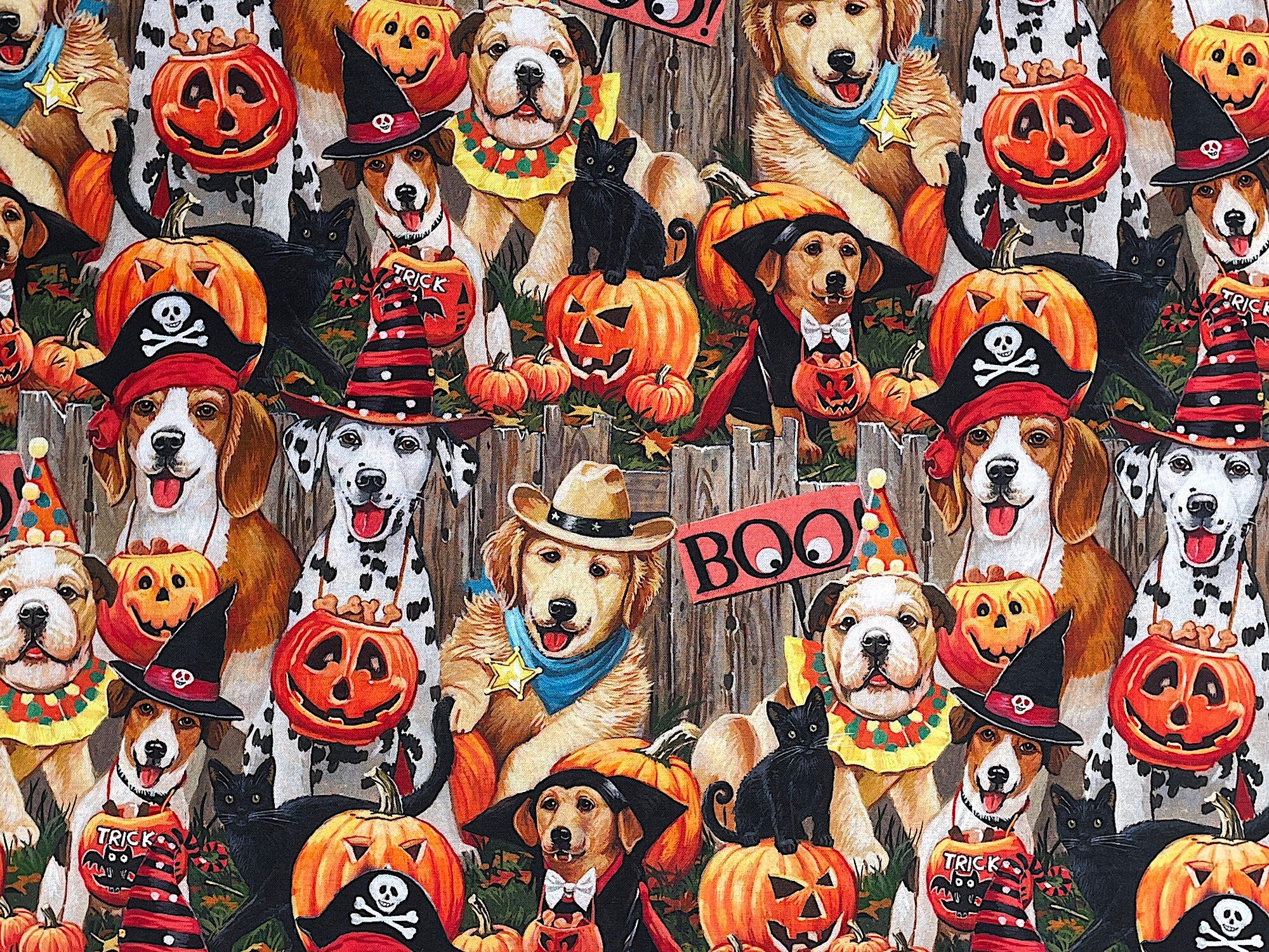 Cotton fabric covered with dogs wearing Halloween costumes.