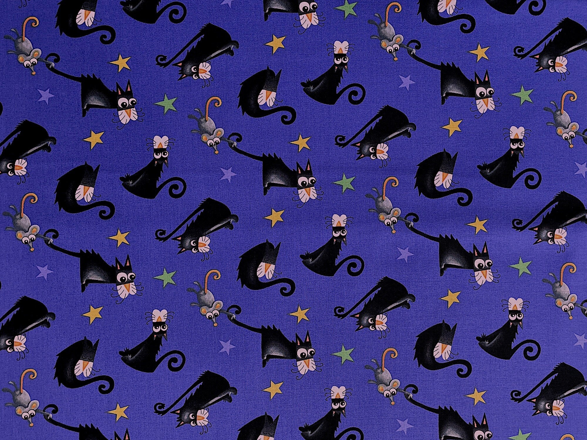 This fabric is called Boo with Glow and is covered with black cats, stars and mice. This fabric glows in the dark.