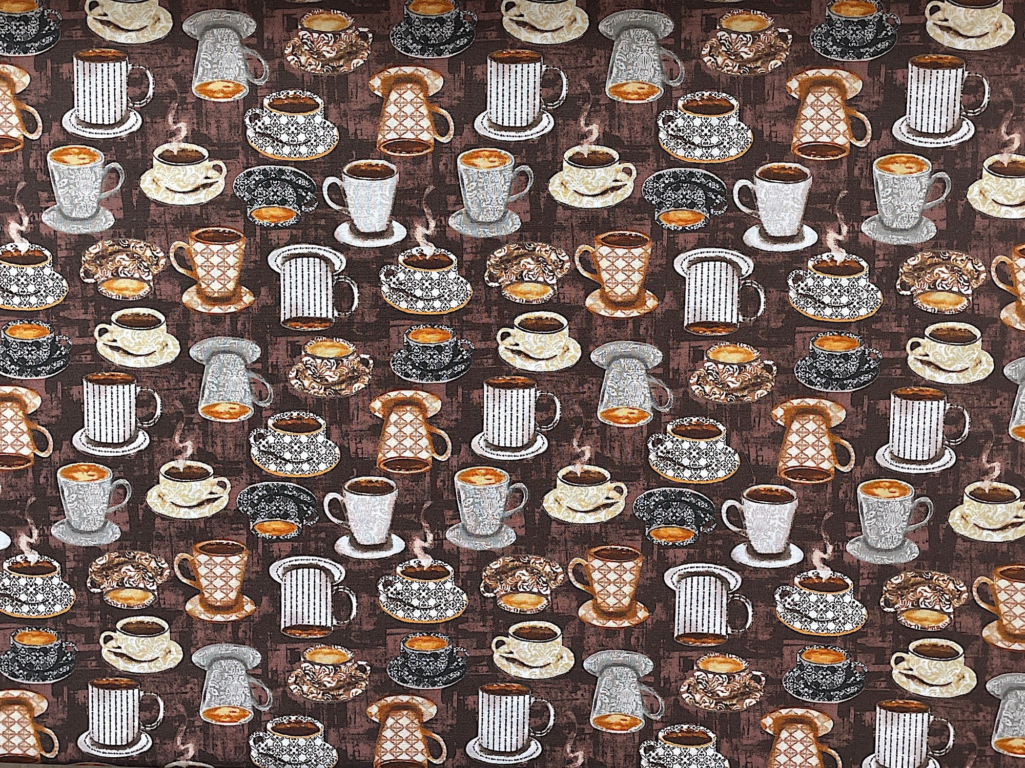 This fabric is part of the Coffee Connoisseur collection by Jean Plout. This brown fabric is covered with coffee cups and mugs filled with coffee sitting on saucers