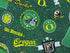 Close up of green cotton fabric covered with Oregon Ducks, the words go ducks, Oregon and more.