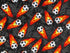 This black cotton fabric is covered with flaming soccer balls.