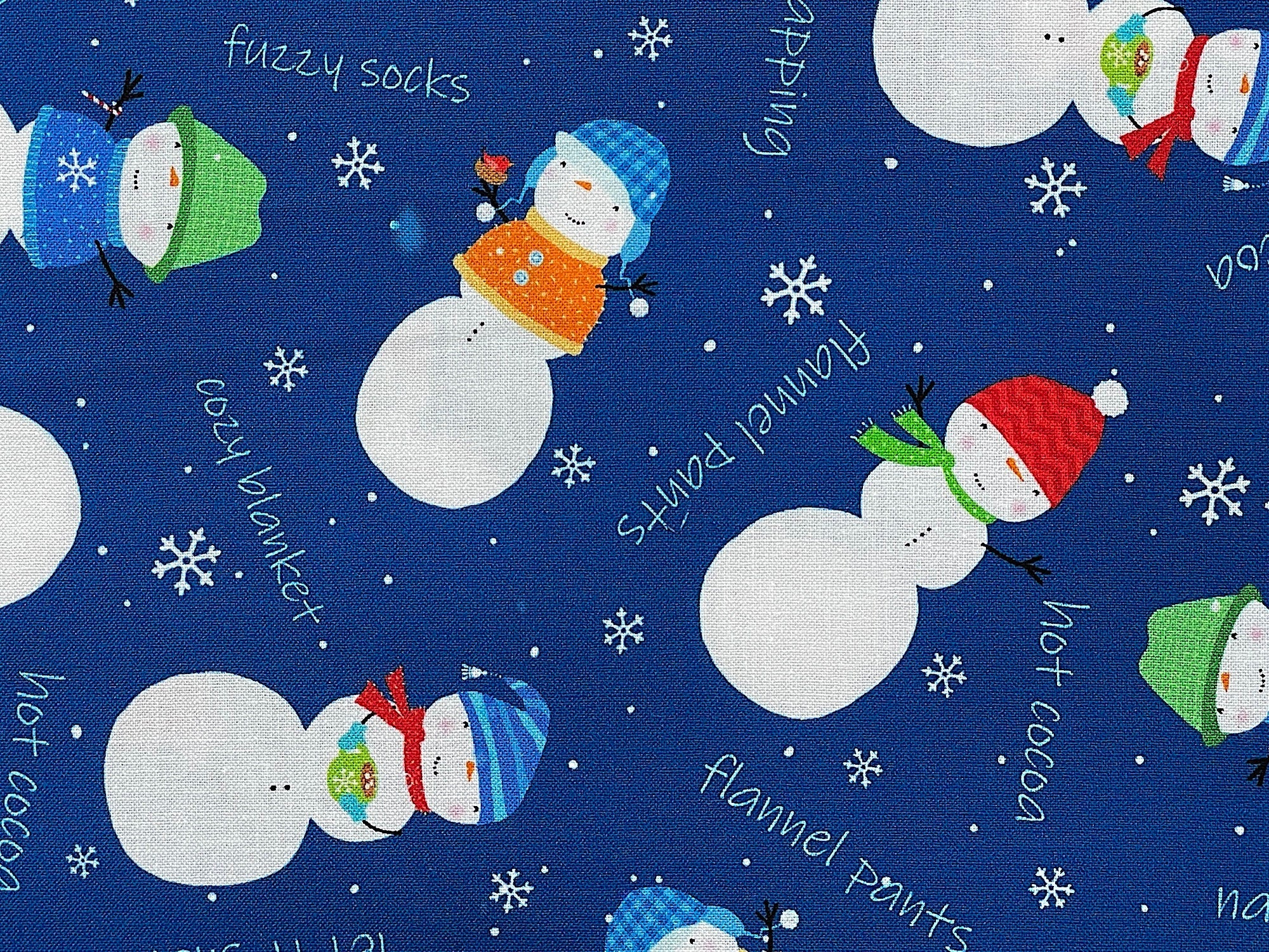 Close up of snowmen and flannel pants, hot cocoa and more.