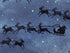 Close up of Santa and his reindeer in the sky.