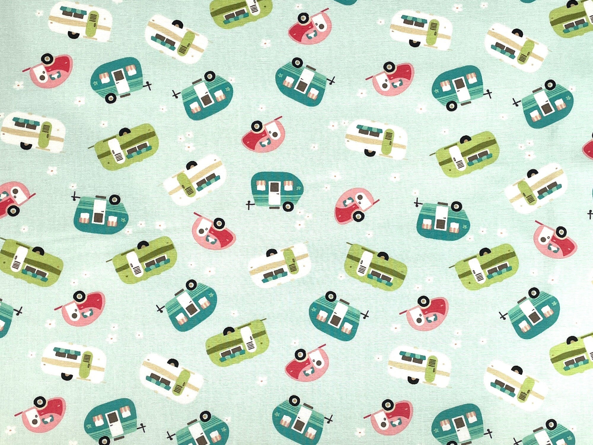 This fabric is called Glamp Camp Travel Trailers. Travel trailers in shades of green, turquoise, tan and pink are tossed over a mint green background.