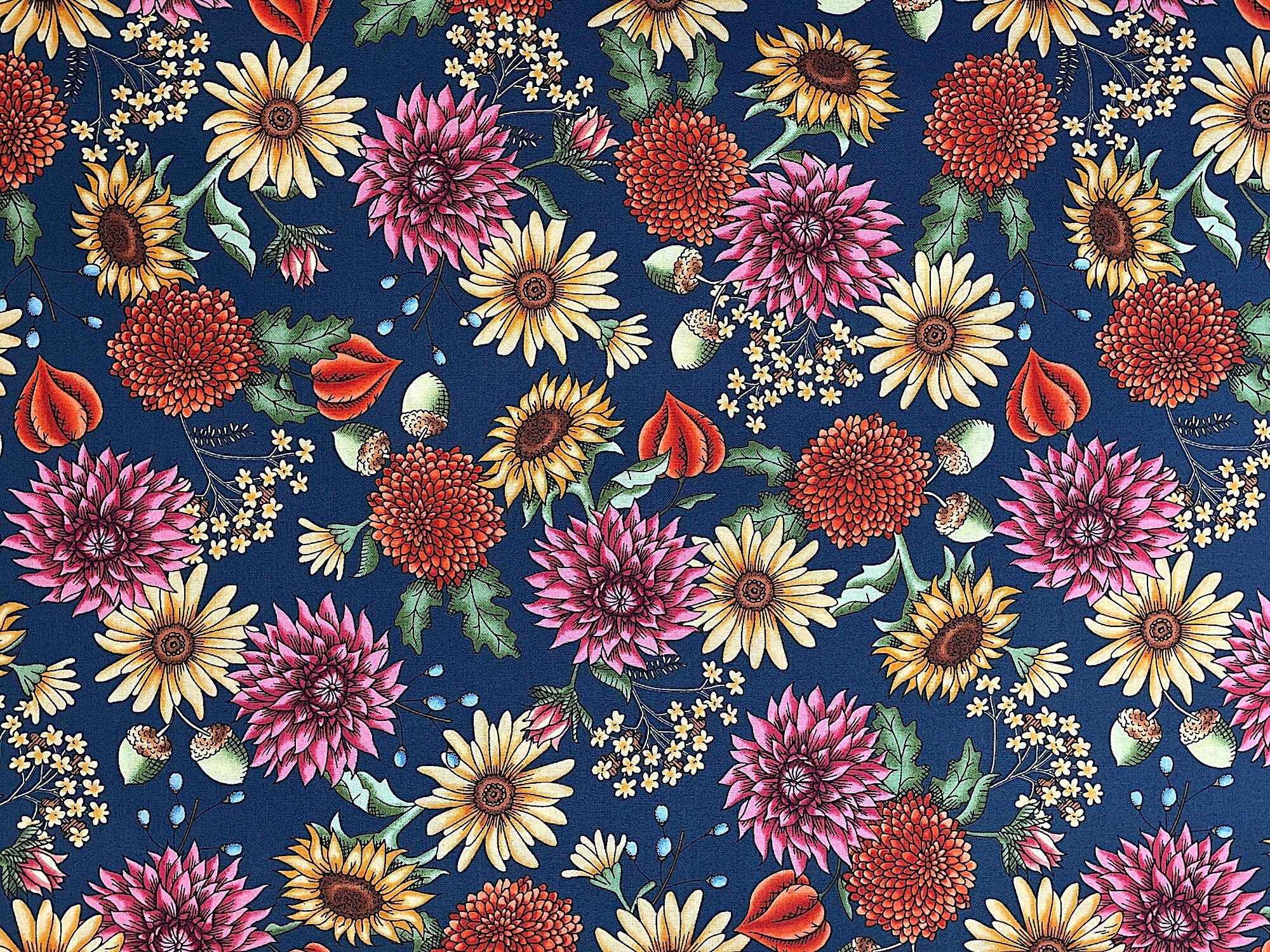 This dark navy blue fabric is covered with flowers. The flowers are yellow, pink, orange and blue.
