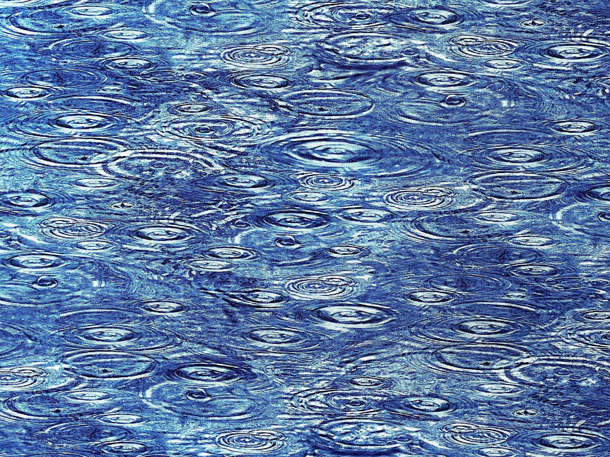 Cotton fabric covered with water falling in water.