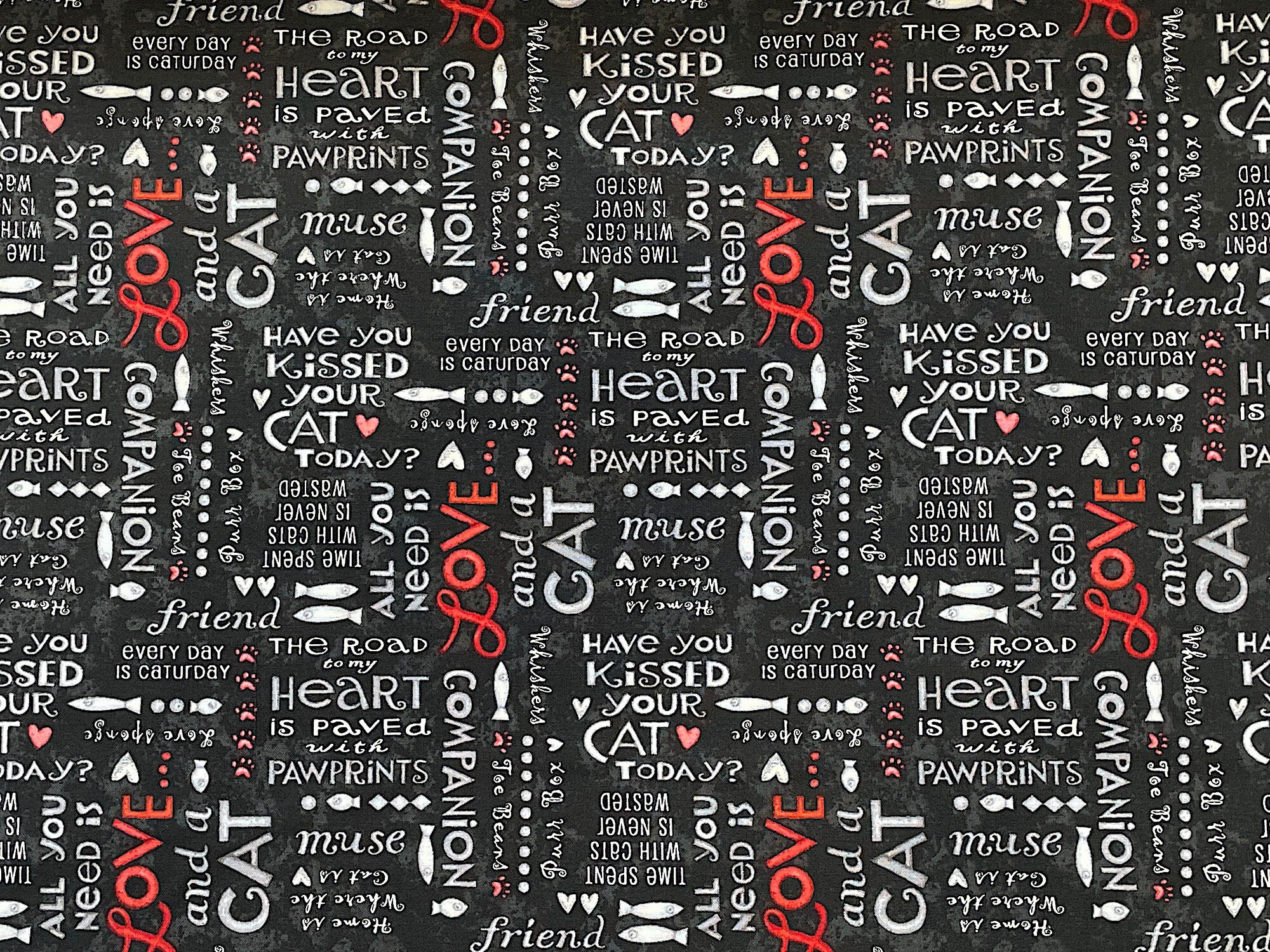 This black cotton fabric is called All You Need is Love and a Cat and is covered with cat sayings such as love, every day is caturday, the road to my heart is paved with pawprints, all you need is love, and more.