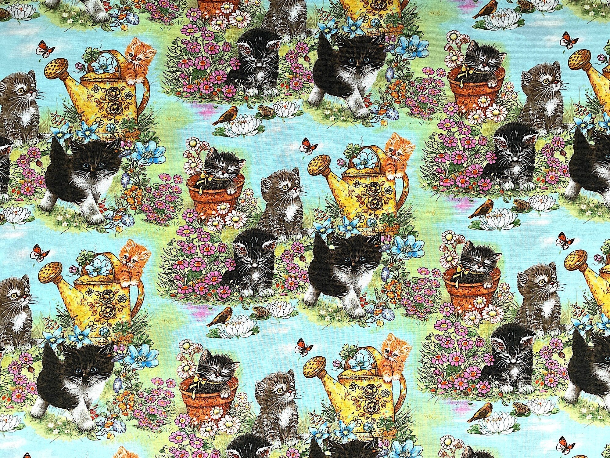 This cotton fabric is covered with cats and flowers. Some of the cats are sleeping in pots, some are watching frogs, butterflies or birds and others are just walking amongst the flowers.