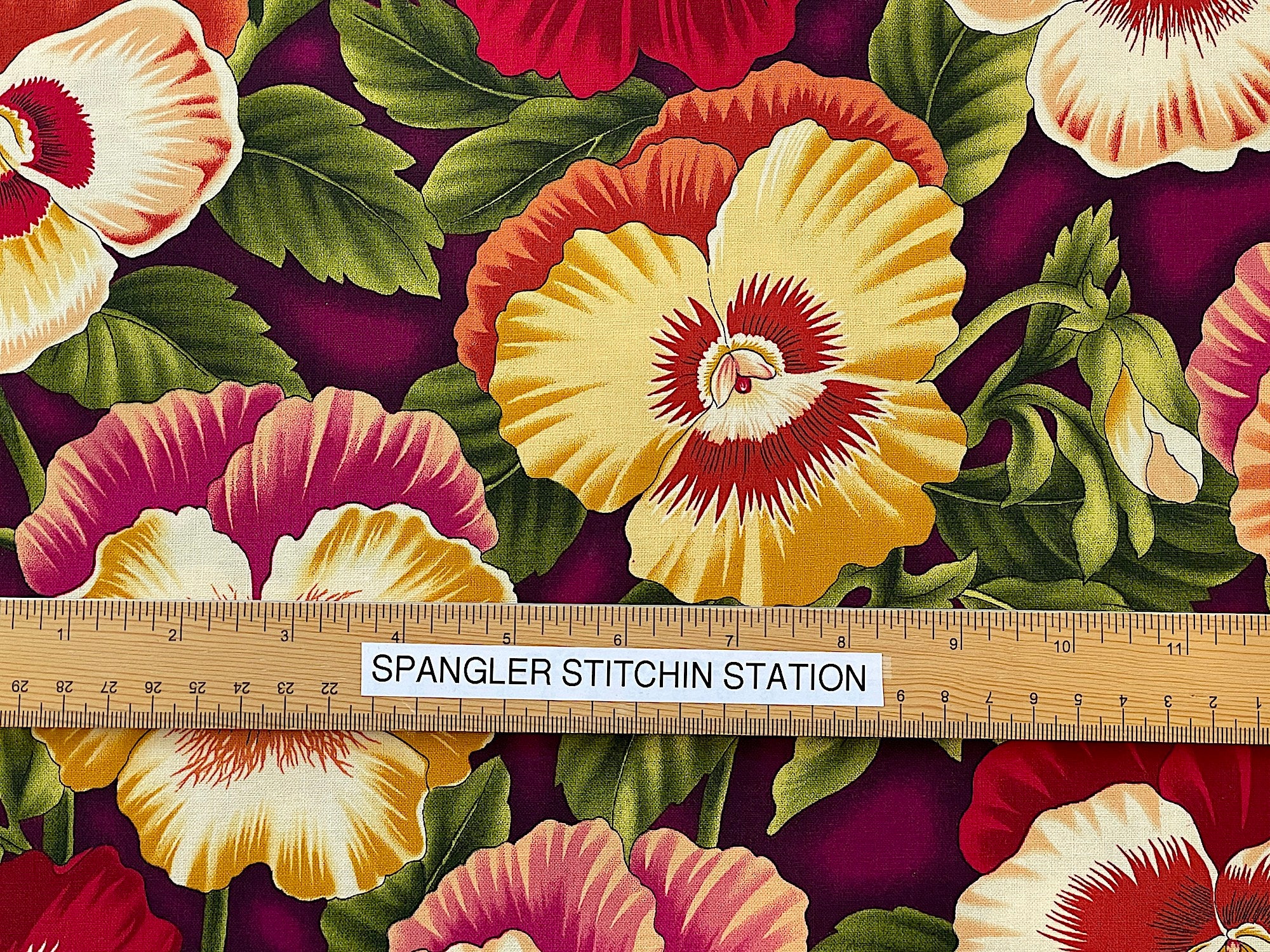 Ruler on fabric to show the size of the pansies.