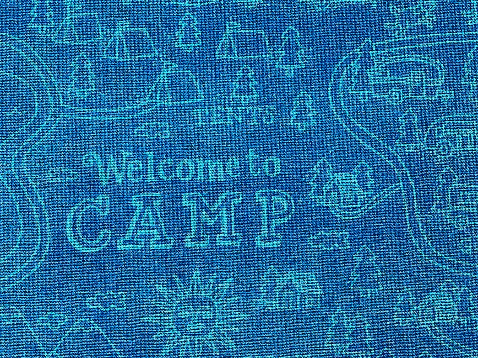 Close up of tents, travel trailers and Welcome to Camp.