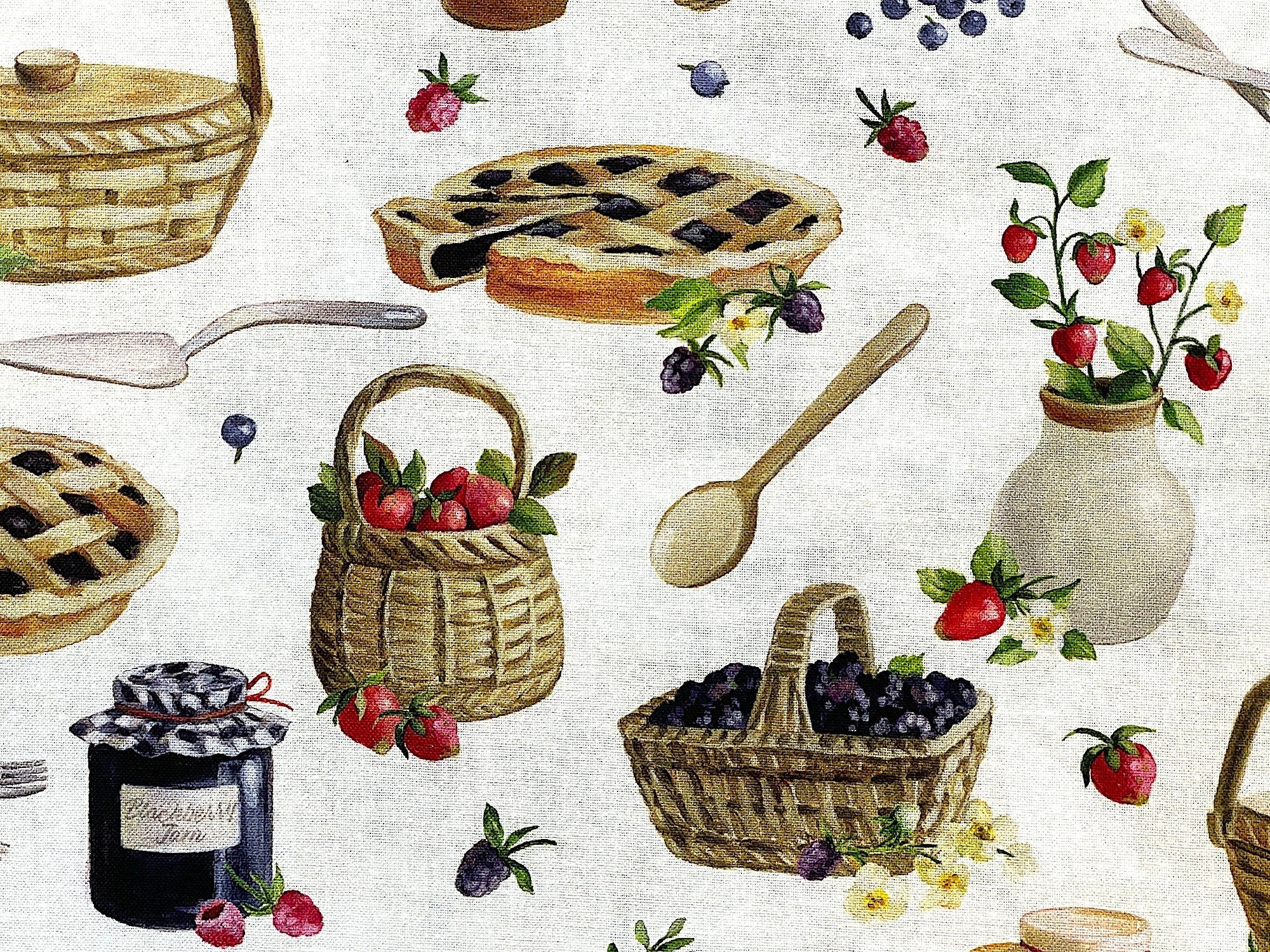 Close up of a basket of strawberries, basket of blueberries and a blueberry pie.