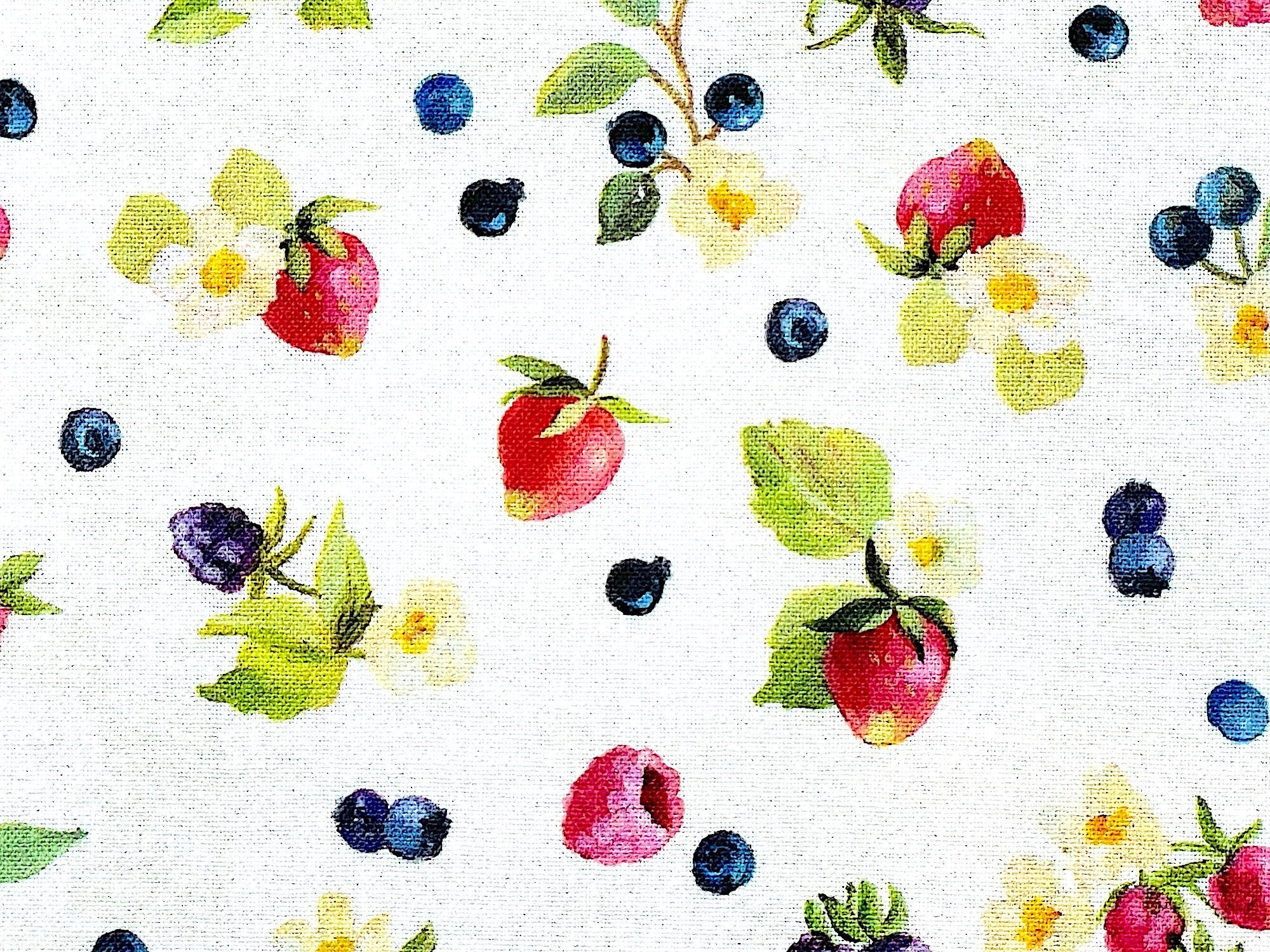Close up of strawberries and blueberries.