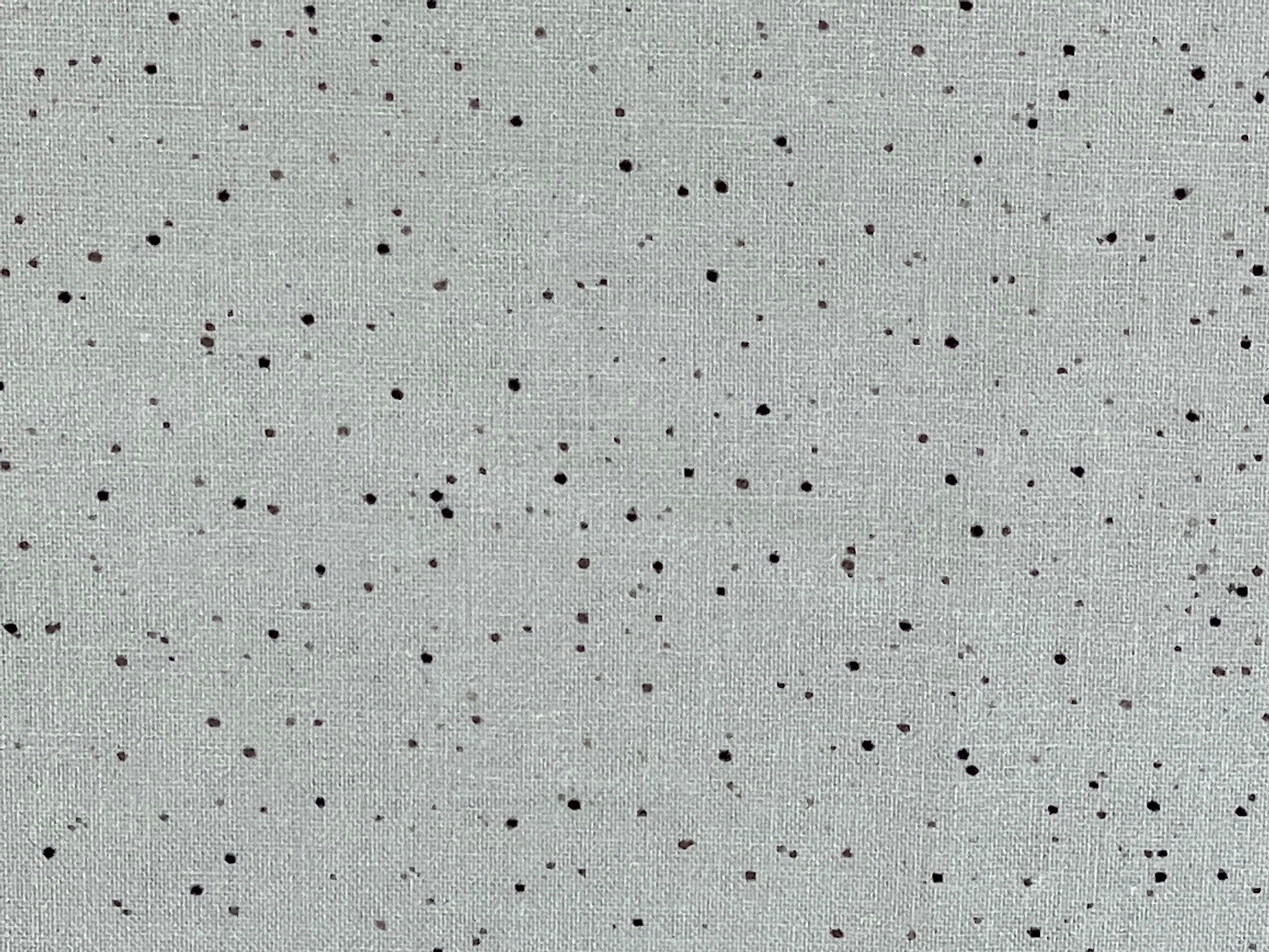 Close up of splatter dots on grey