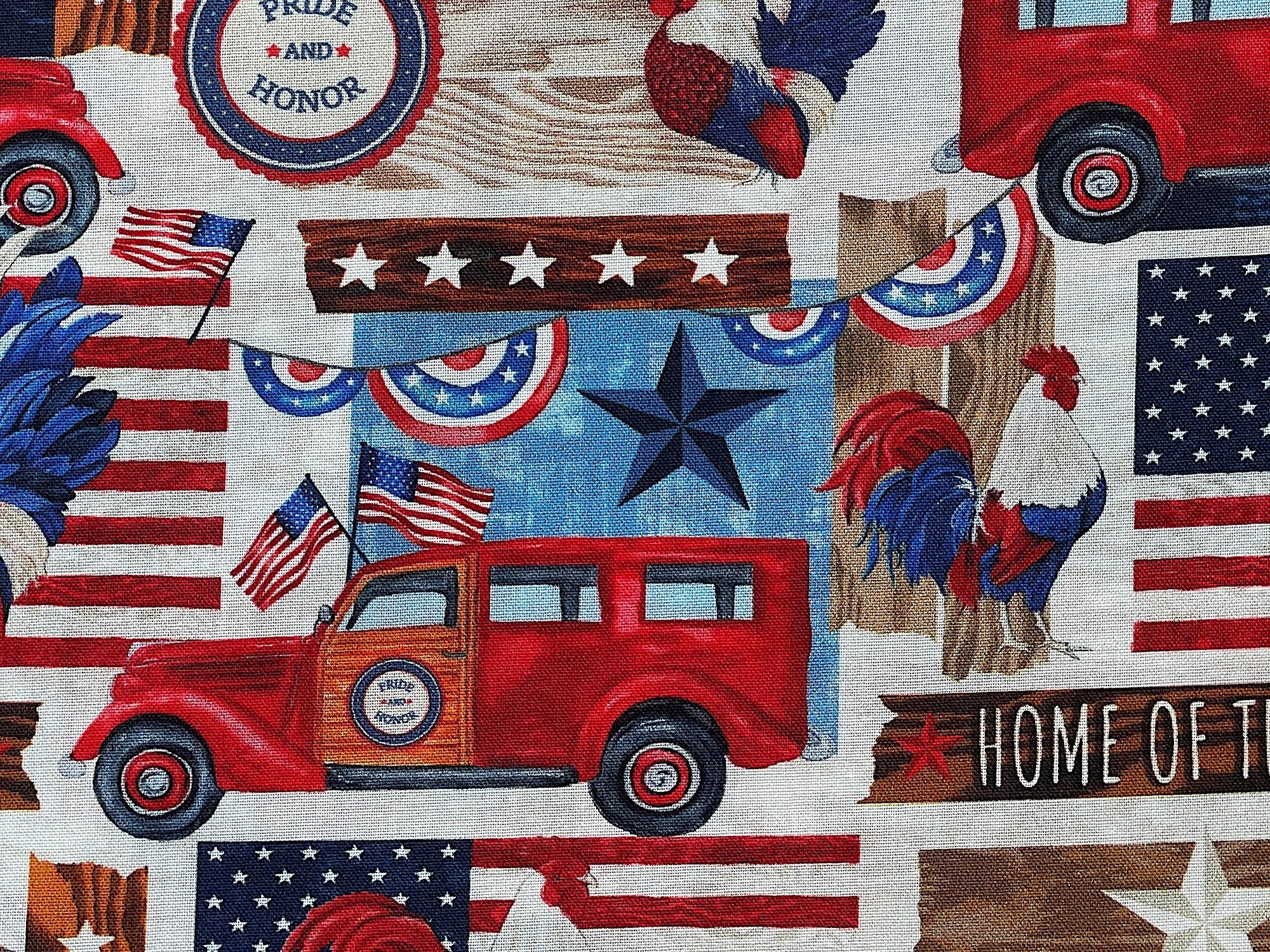 Close up of a red truck, pride and honor sign, red, white and blue rooster and more.
