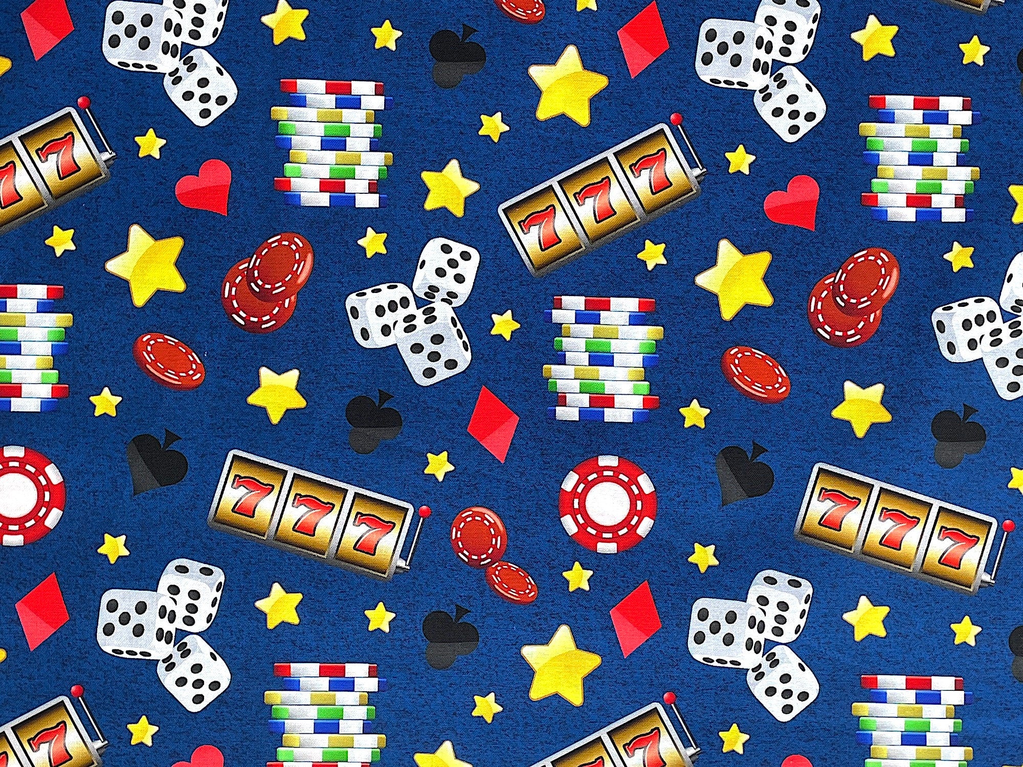 This blue casino fabric is covered with dice, game chips, stars hearts, diamonds and more