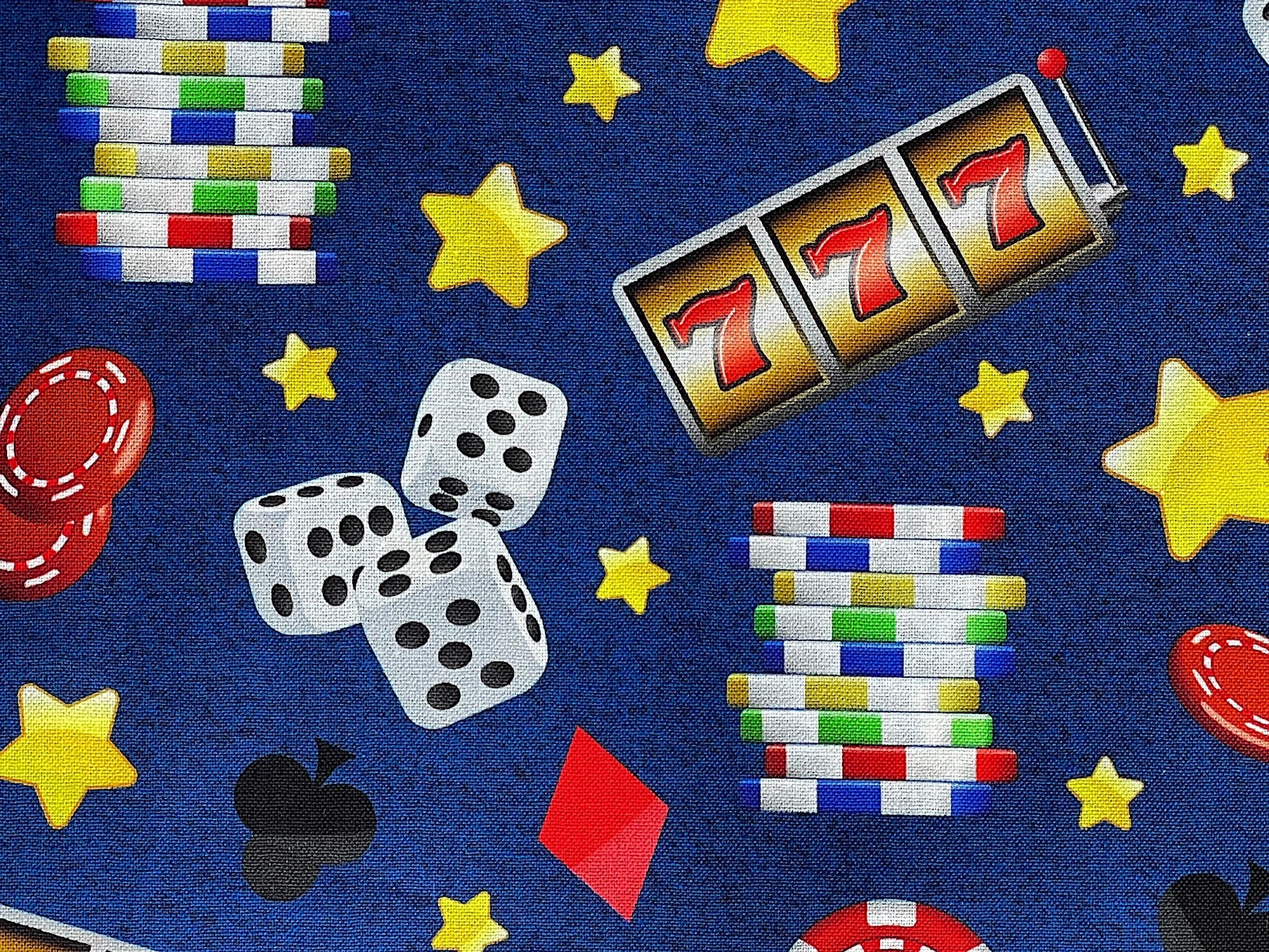 Close up of poker chips, dice, three sevens and more.
