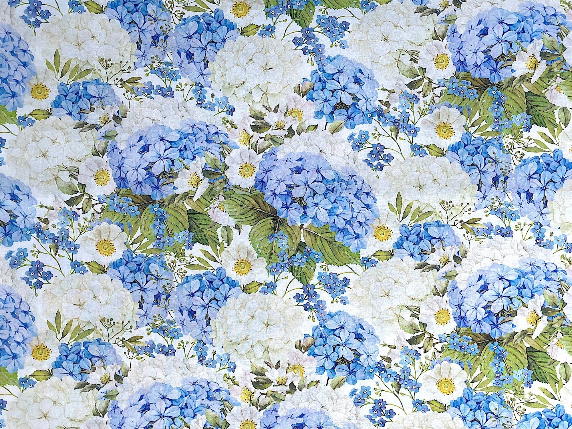 Cotton fabric covered with white and blue packed hibiscus.