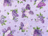 Lavender cotton fabric covered with bunches of white and purple lilacs.