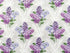 Cotton fabric covered with bunches of white and purple lilacs on a grey patterned background.