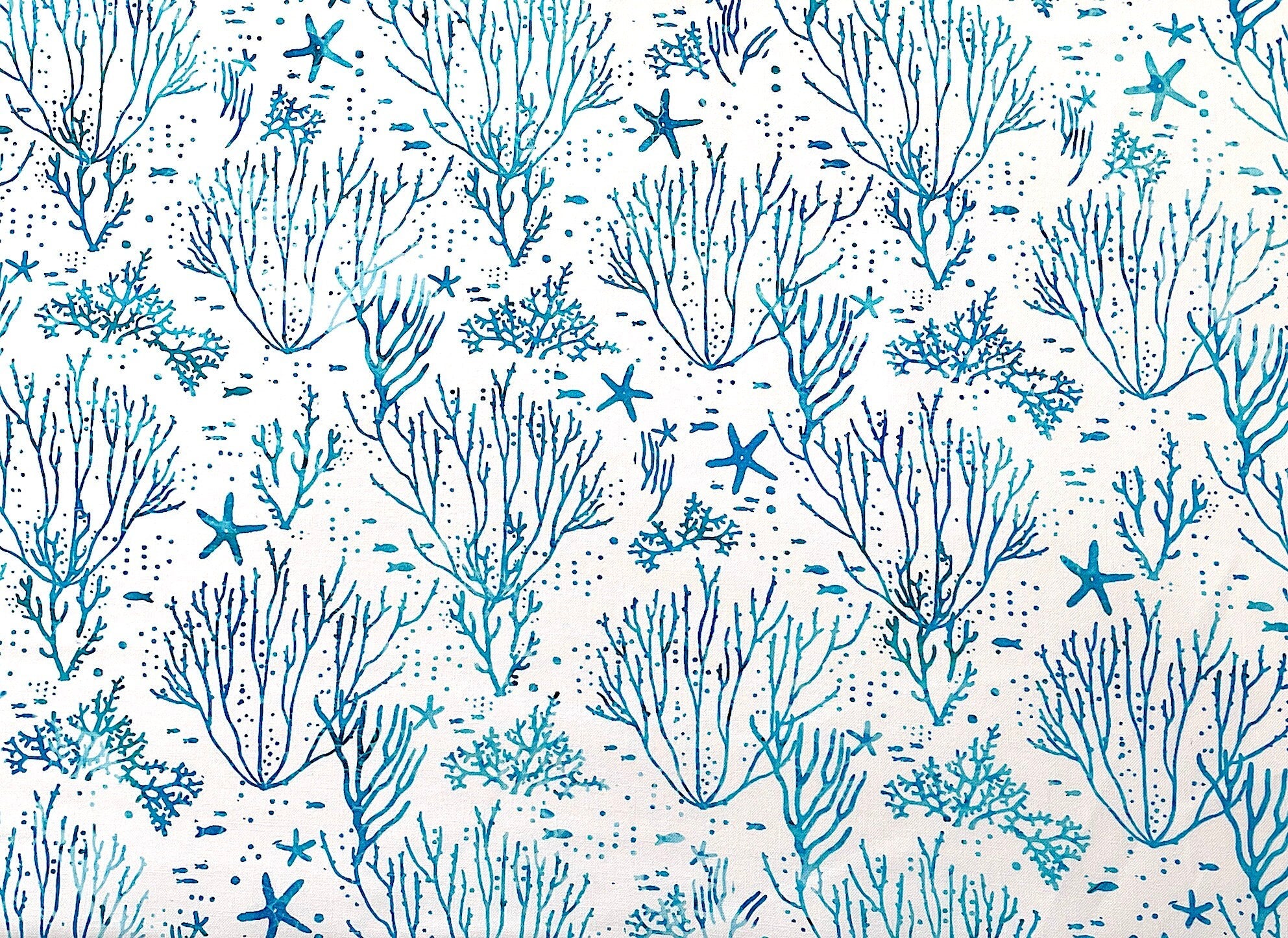 White cotton fabric covered with blue coral.